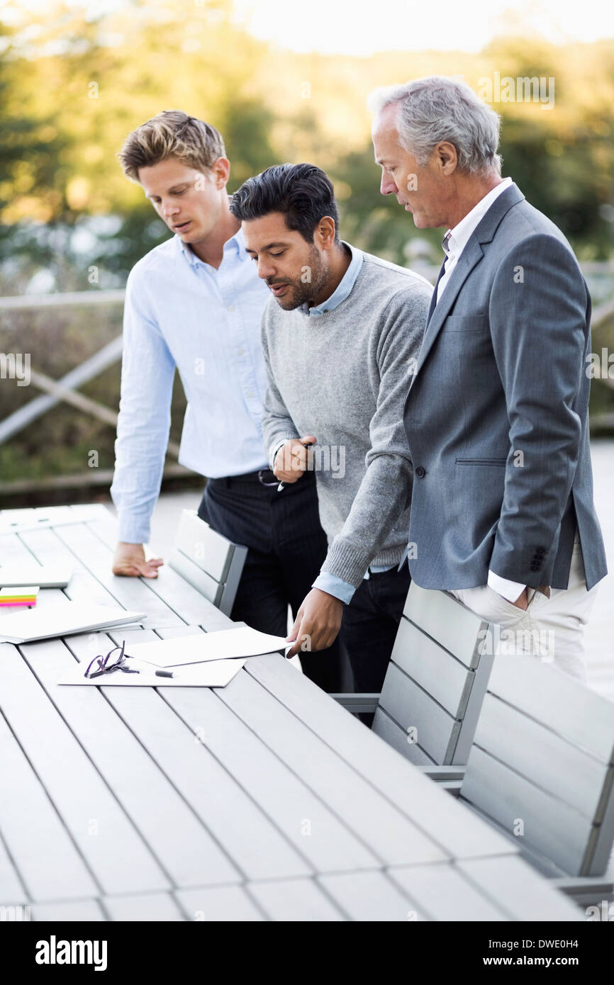 Businessmen working on patio Stock Photo