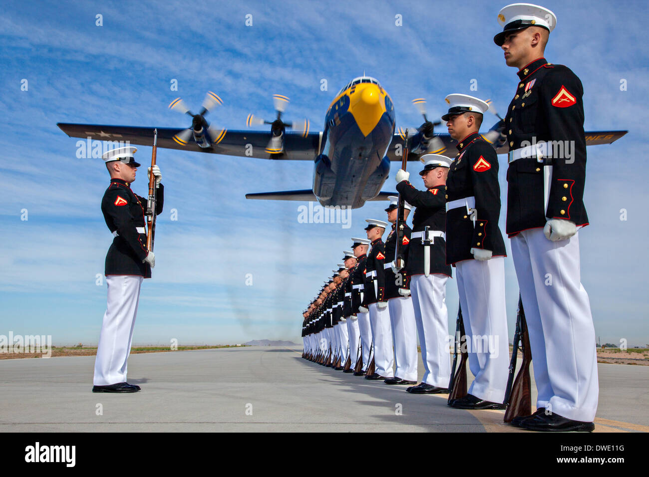 The US Marine Corps Blue Angels C-130 Hercules aircraft, affectionately known as Fat Albert, flies over the Silent Drill Platoon during air show rehearsal March 4, 2014 at Marine Corps Air Station Yuma, Arizona. Stock Photo