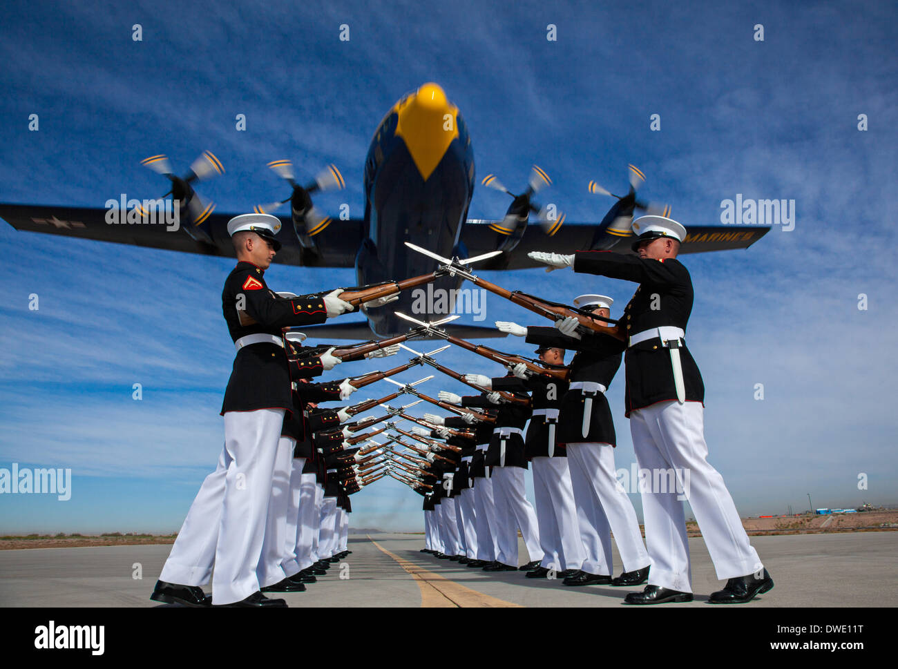 The US Marine Corps Blue Angels C-130 Hercules aircraft, affectionately known as Fat Albert, flies over the Silent Drill Platoon during air show rehearsal March 4, 2014 at Marine Corps Air Station Yuma, Arizona. Stock Photo