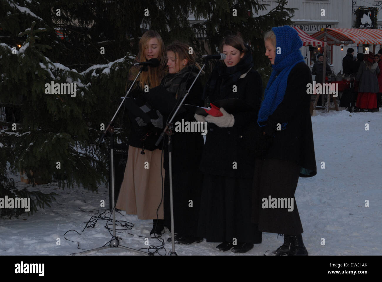 Carolers singing at a Christmas market. Stock Photo