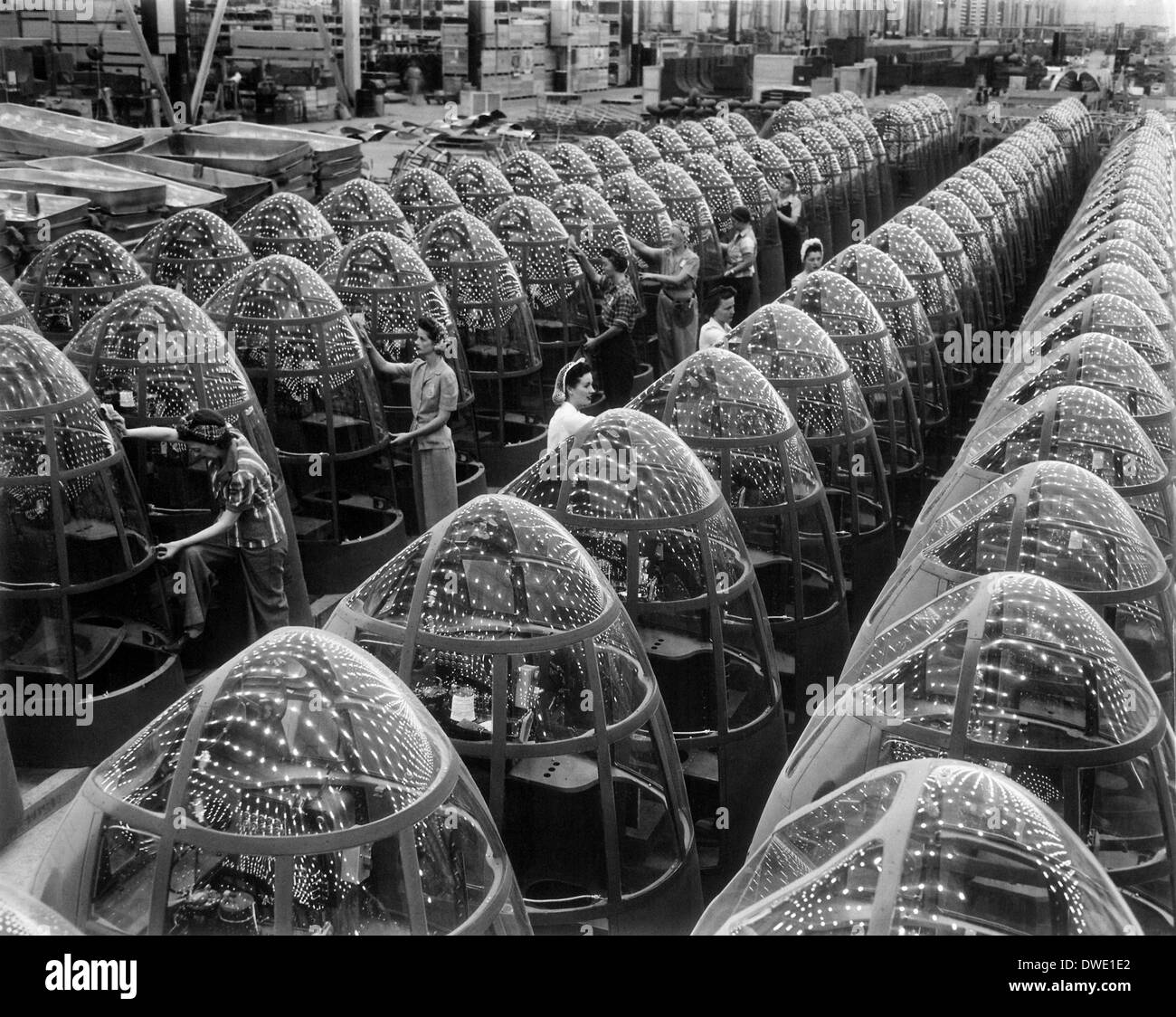 Women workers known as Rosie the Riveters polish the transparent nose cones for A-20 attack bomber aircraft at the Douglas Aircraft factory October 1942 in Long Beach, CA. Stock Photo