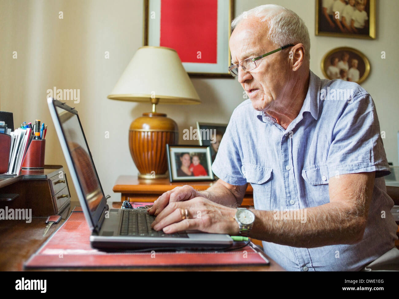 Senior man types using laptop hi-res stock photography and images - Alamy
