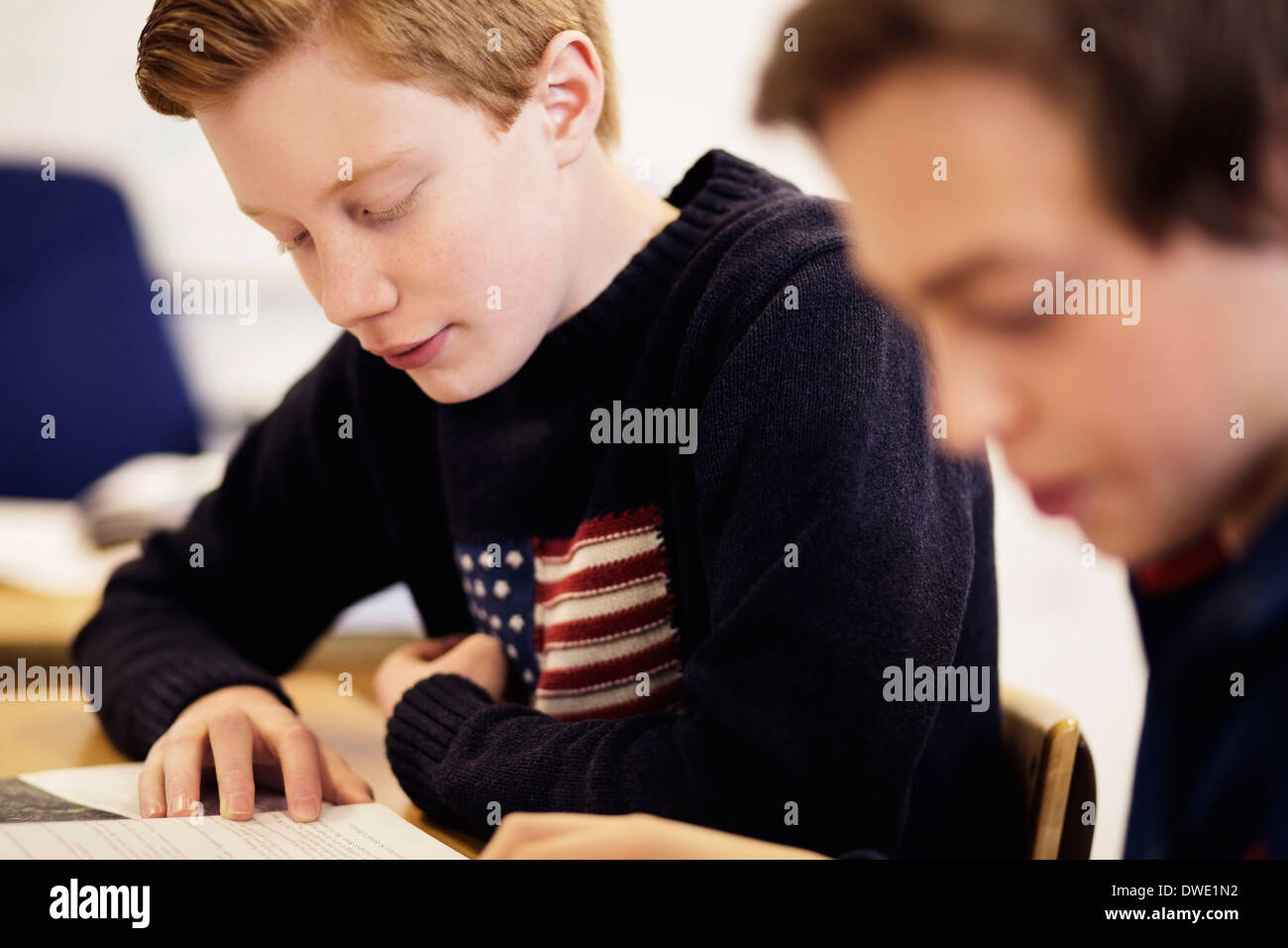 High school boys studying together in classroom Stock Photo