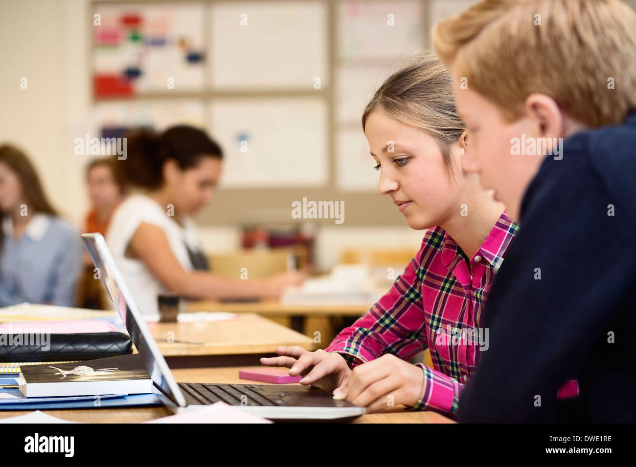 High school students using laptop in classroom Stock Photo