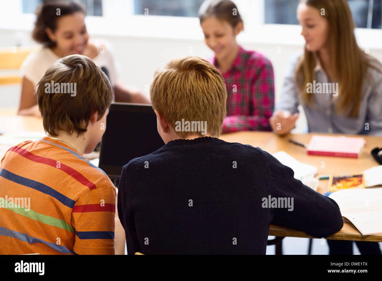 High school students using laptop in classroom Stock Photo