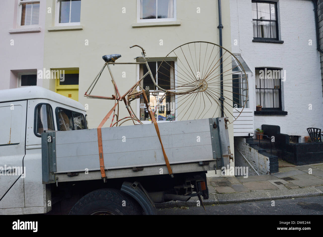 A parked truck carrying an unusual  large bicycle Stock Photo