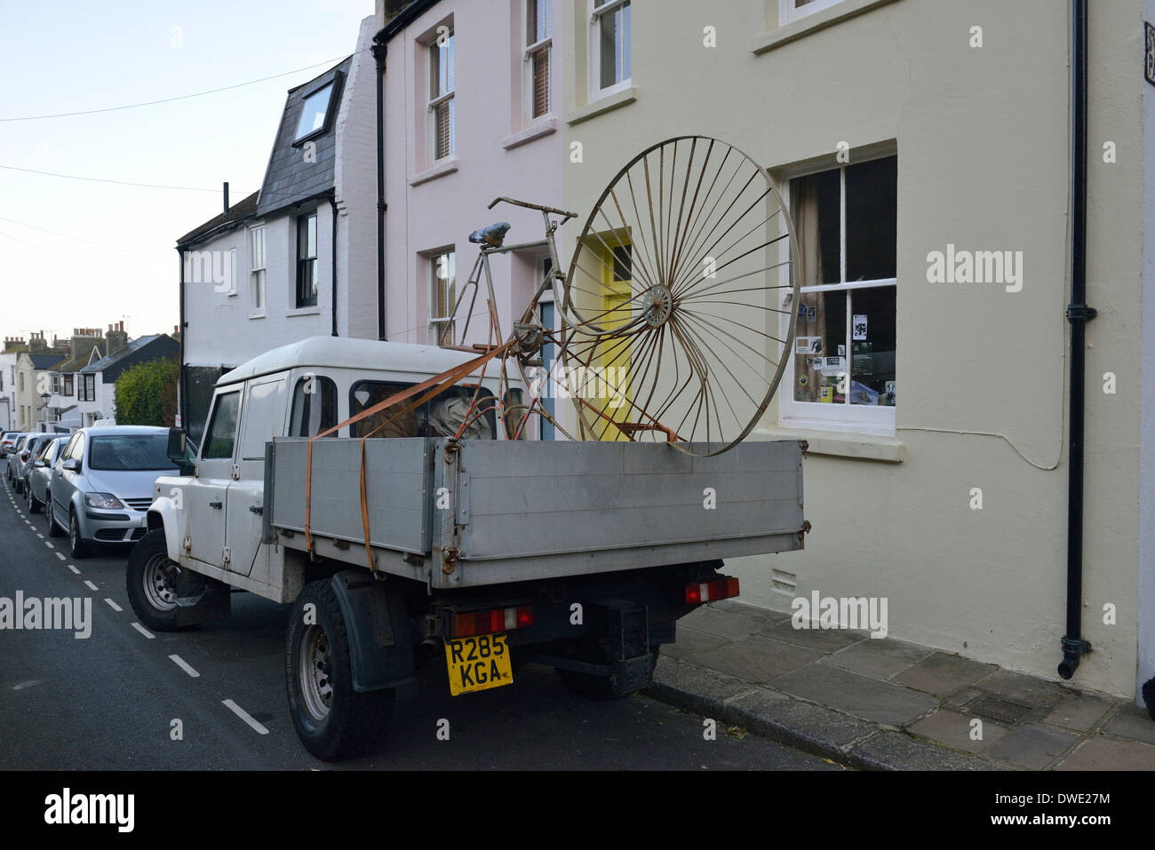 A parked truck carrying an unusual  large bicycle Stock Photo