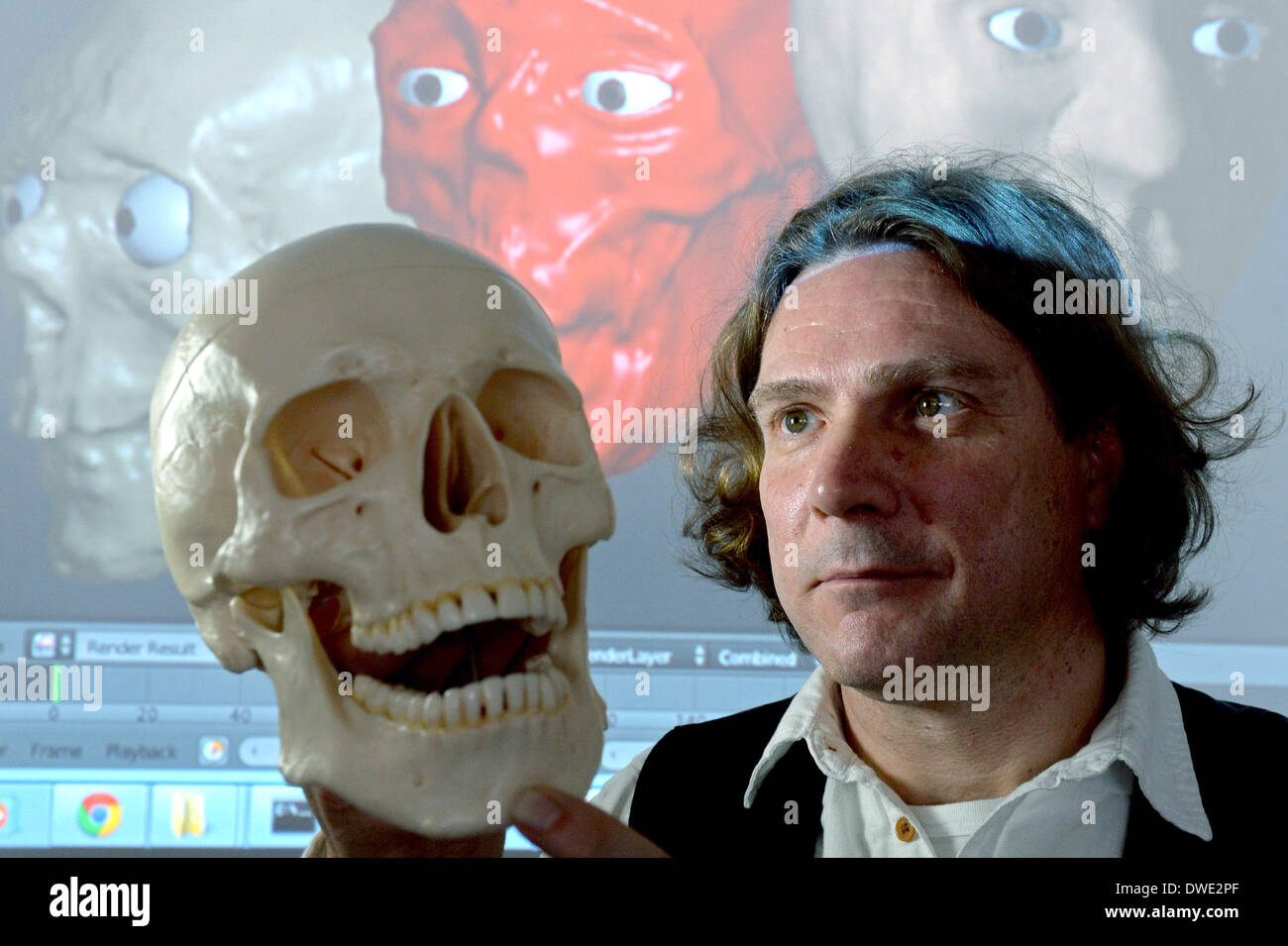 Mittweida, Germany. 06th Mar, 2014. Prof. Dirk Labudde looks at a skull in front of a computer screen with a digital facial reconstruction as part of the course "digital forensics" at the academy in Mittweida, Germany, 06 March 2014. A new bachelor program "general and digital forensics" will be offered for the coming winter semester. Mittweida researchers have already been working in cooperation with the police for a long time in this area. The police see ever increasing demands and needs for specialists in connection with cyber crime. Photo: HENDRIK SCHMIDT/dpa/Alamy Live News Stock Photo