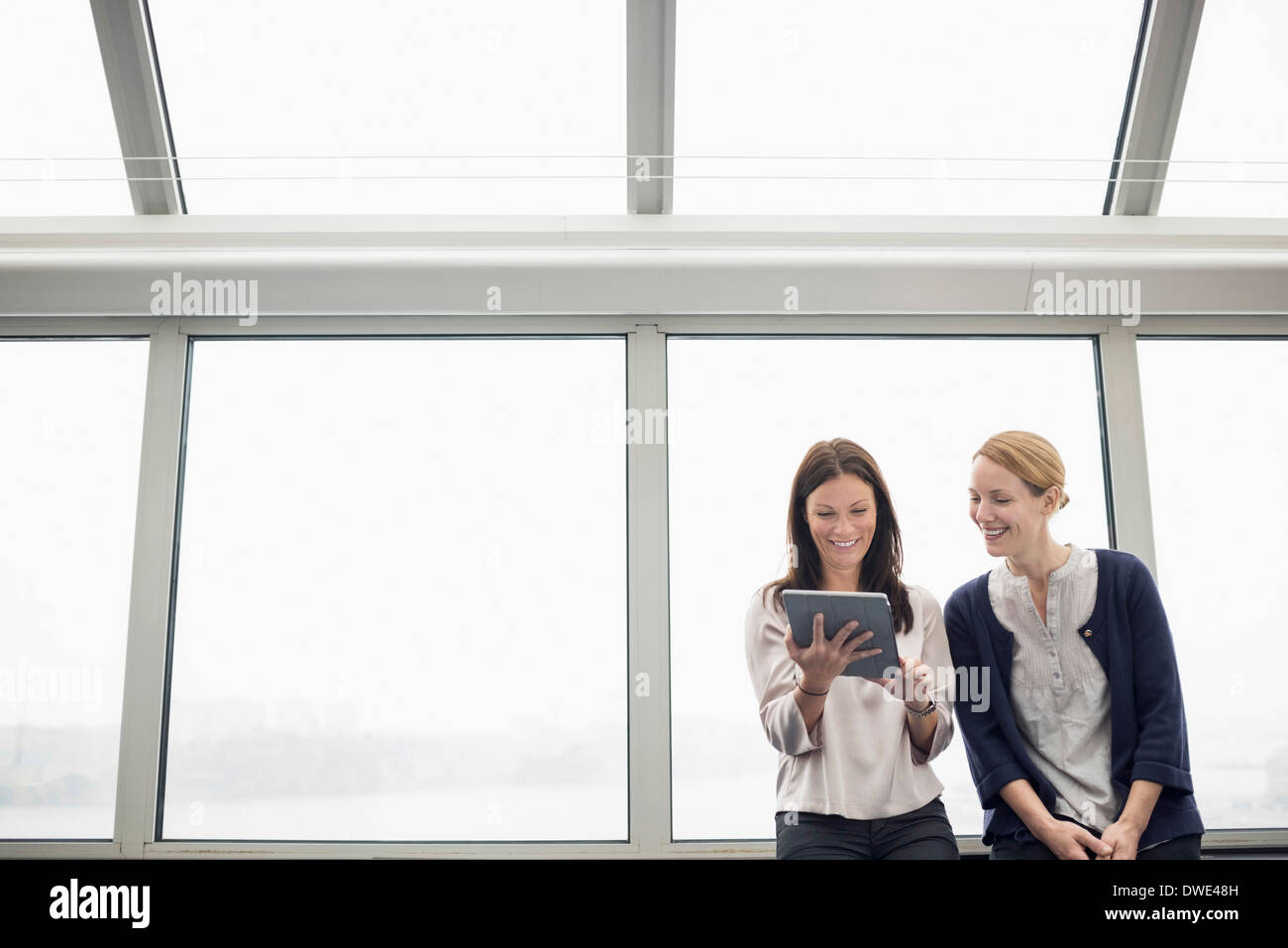 Businesswomen using digital tablet in office Stock Photo