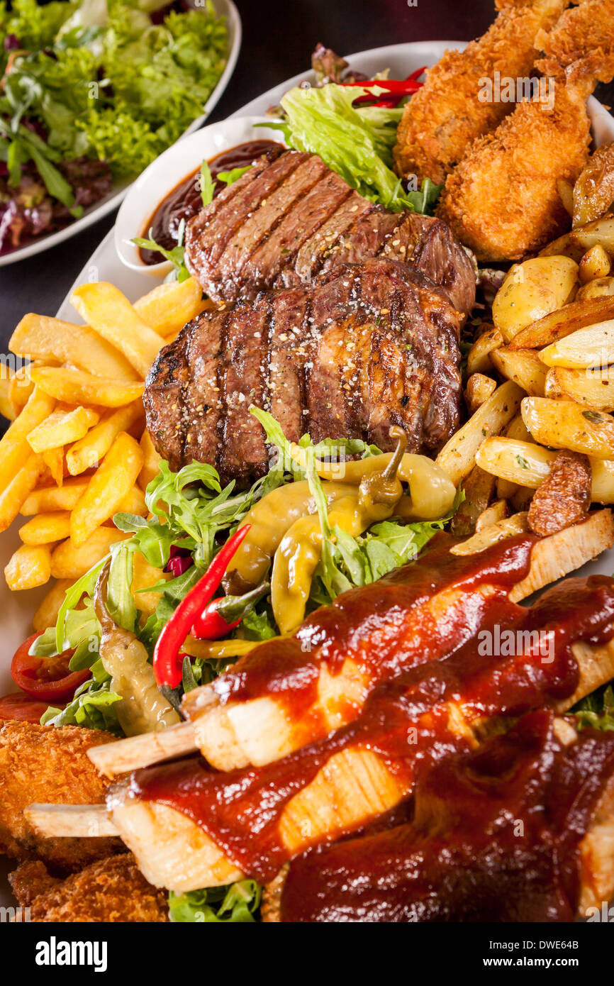 Wholesome platter of mixed meats including grilled steak, crispy