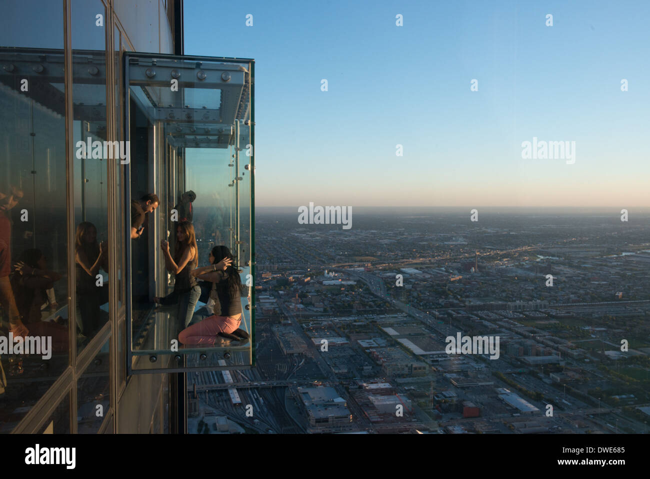 Visitors stand on The Ledge, a transparent viewing platform 1353 feet above ground on the Willis Tower in Chicago, Illinois. Stock Photo