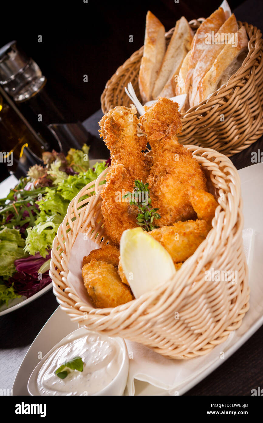 Crisp crunchy golden chicken legs and wings deep fried in bread crumbs