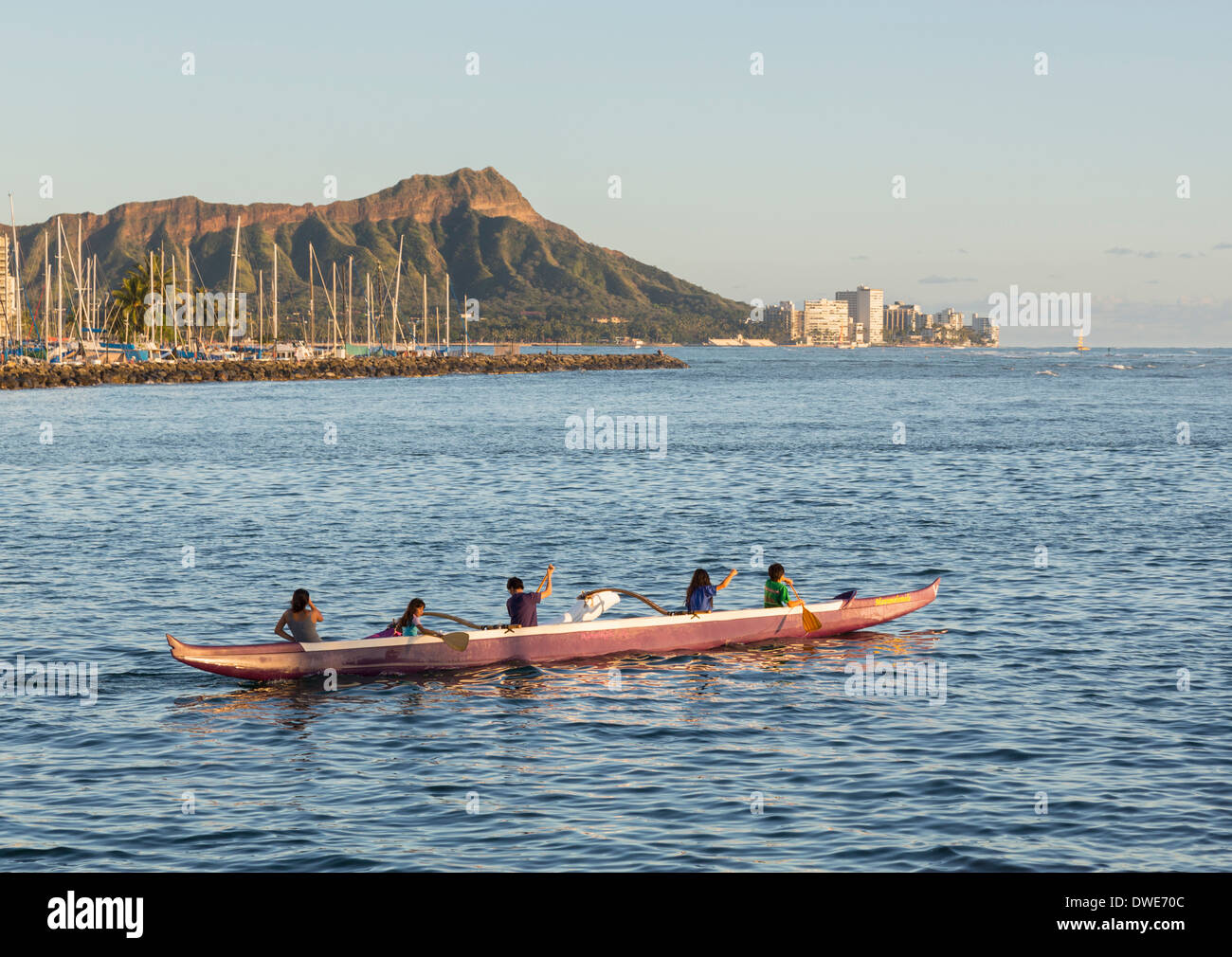Honolulu, Hawaii, USA Group of boys and girls paddle an outrigger
