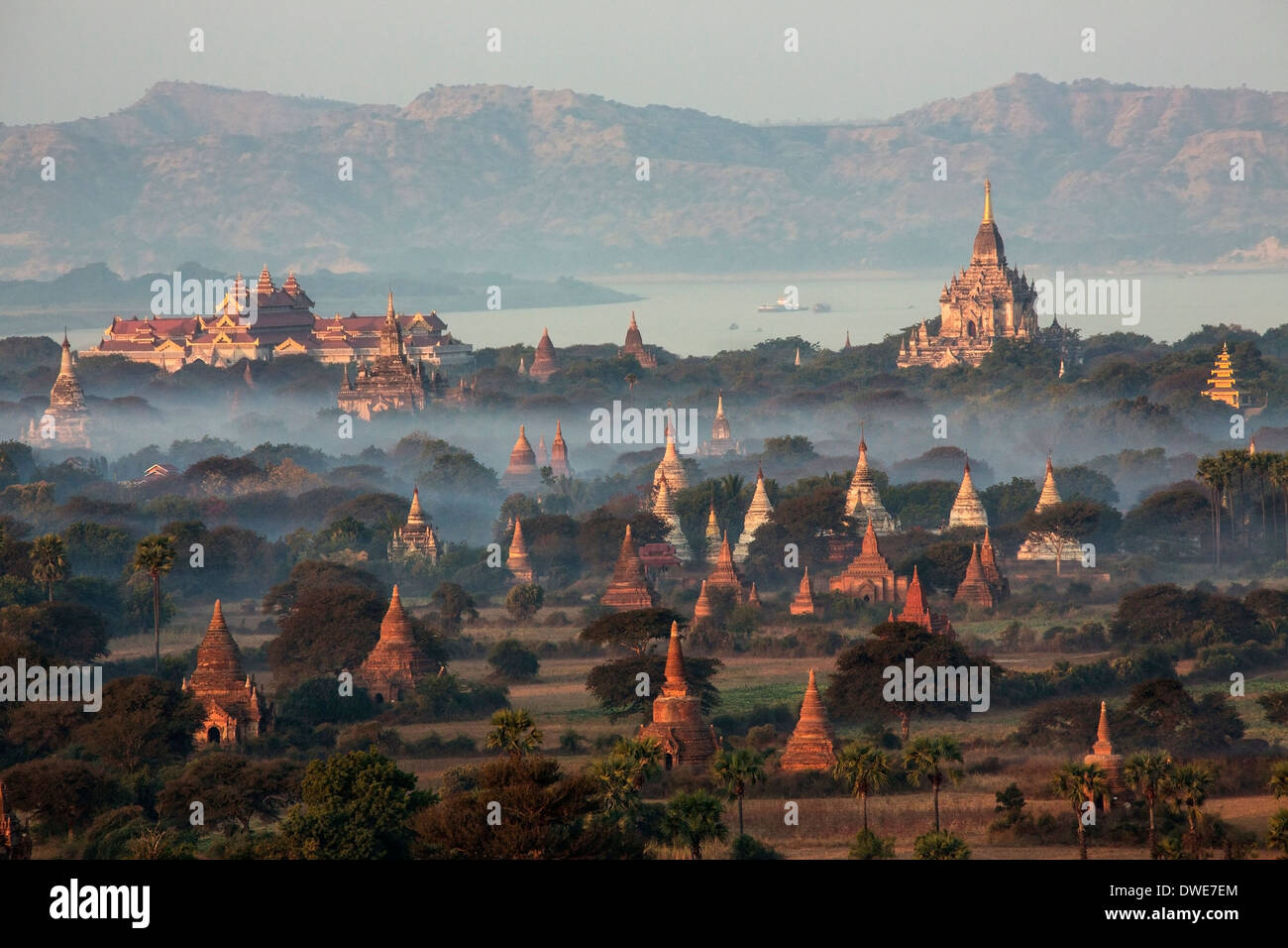 The temples of the Archaeological Zone in Bagan in the early morning sunlight. In the distance is the Irrawaddy River. Myanmar Stock Photo