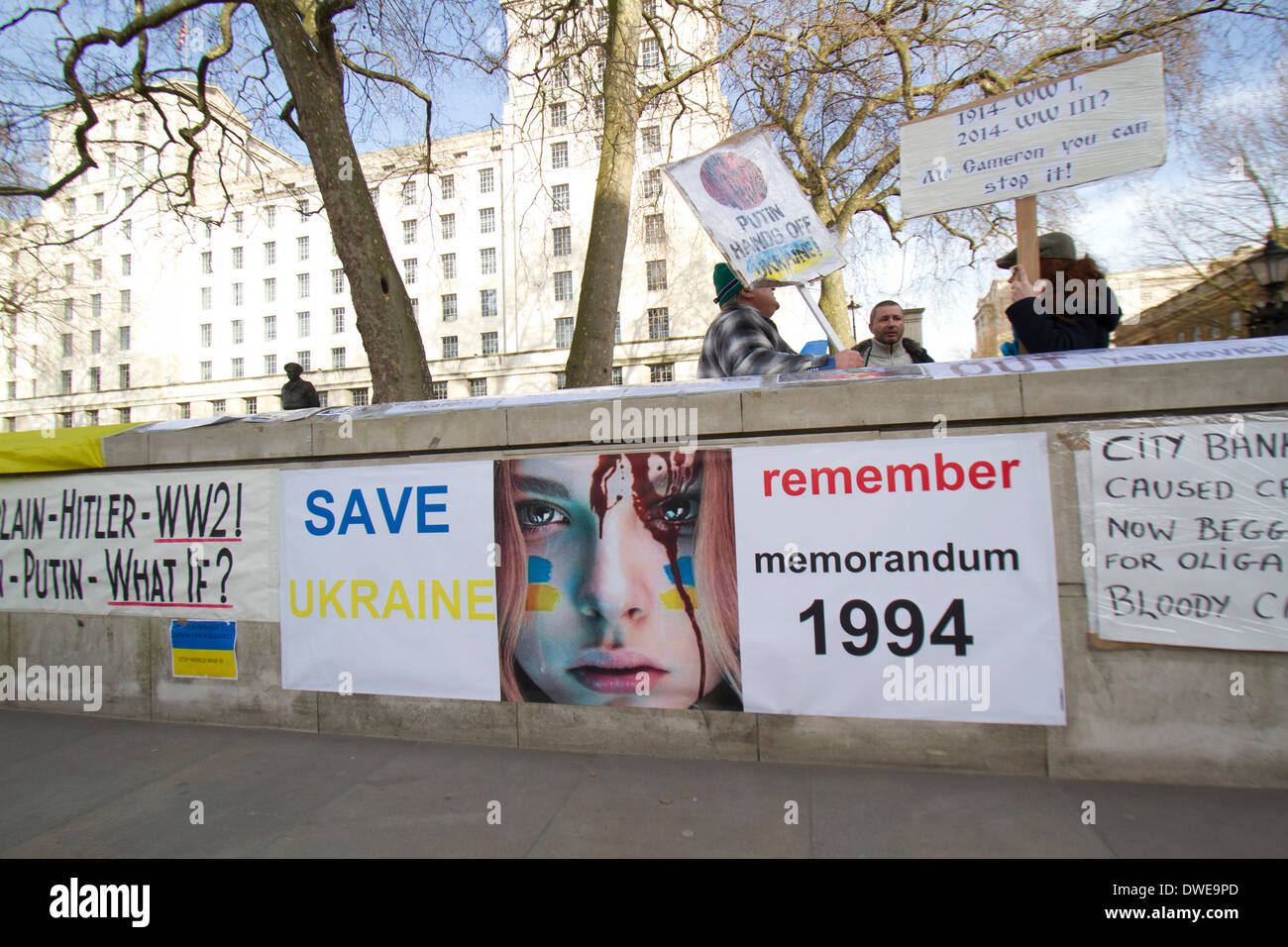 Westminster London ,UK. 6th March 2014. Ukrainian protesters continue to hold a 24hour shift protest outside Downing Street with placards following the Russian military intervention in the Crimea demanding on the British Government to keep its promises on the Budapest memorandum on Security Assurances signed in 1994.The Memorandum included security assurances against threats or use of force against the territorial integrity or political independence of Ukraine and as a result Ukraine gave up its stockpile of Nuclear weapons between 1994 and 1996. Credit:  amer ghazzal/Alamy Live News Stock Photo