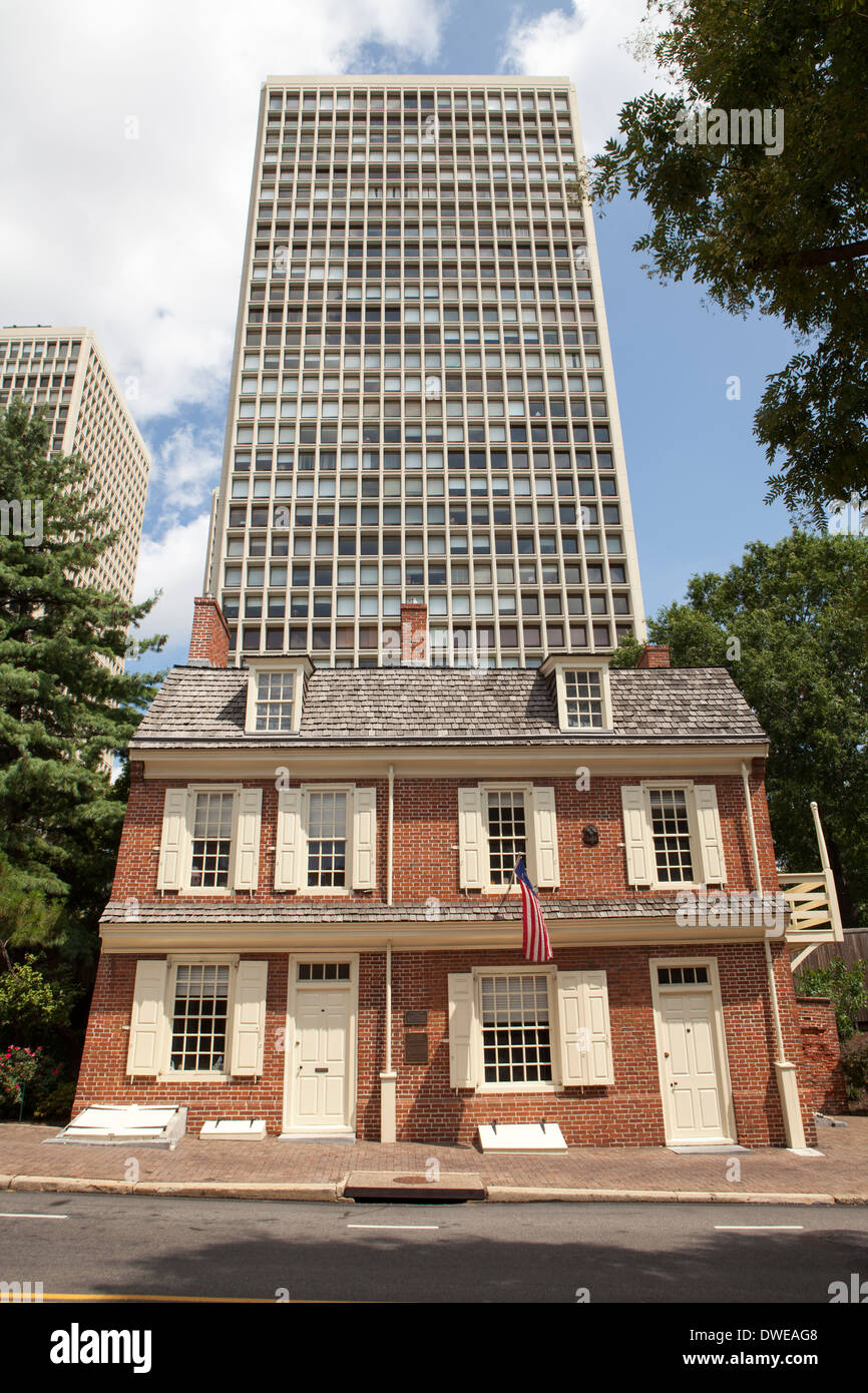 On old office block towers above a traditional residential town house ...