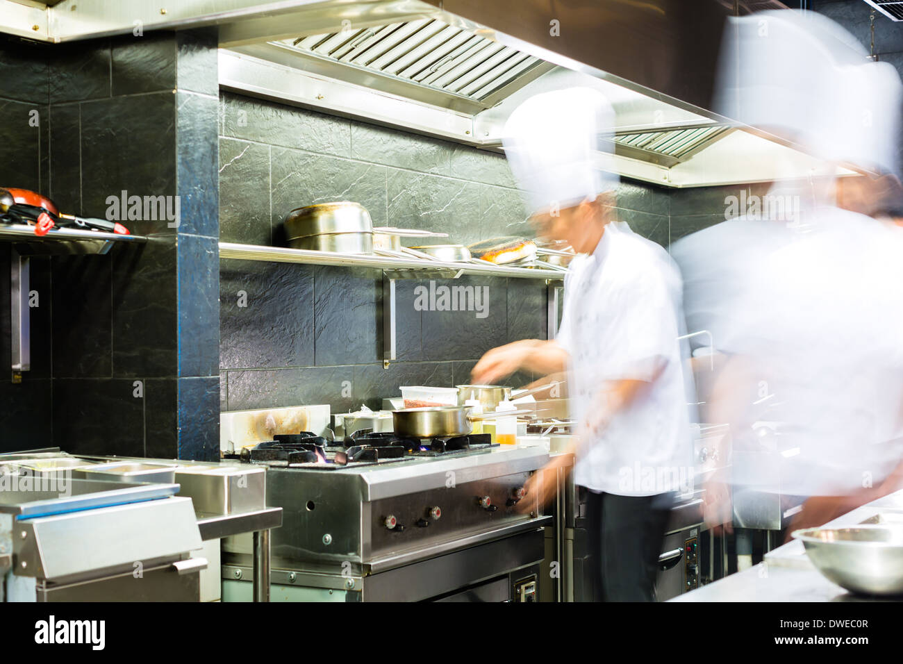 Chef cooking in the kitchen of a restaurant Stock Photo