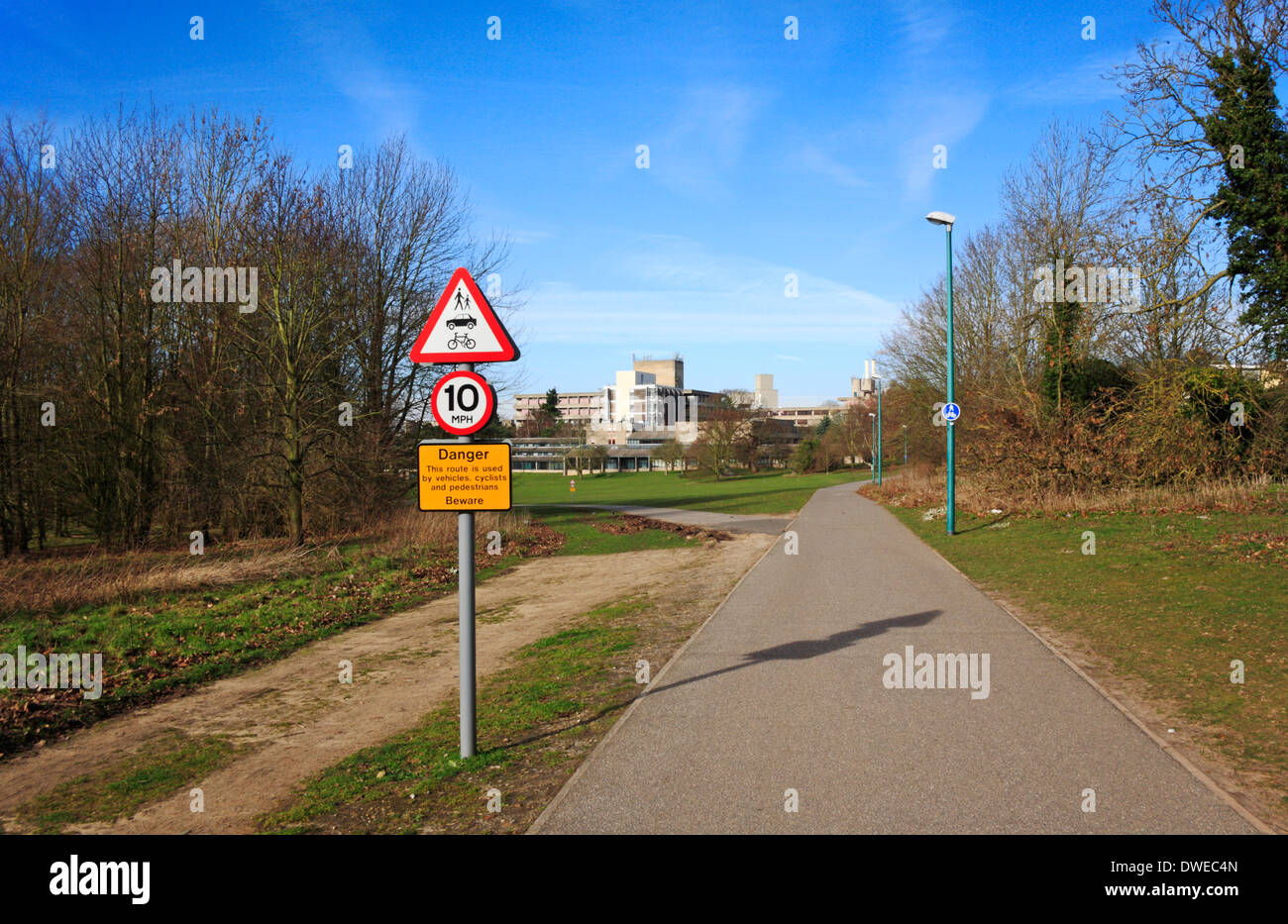 A speed limit and traffic awareness sign at an entrance to the