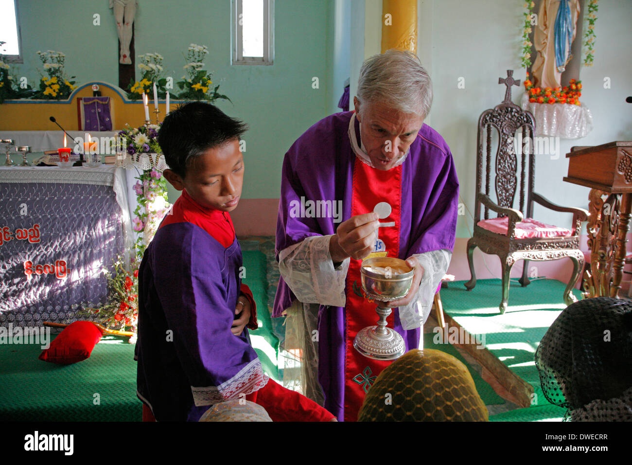 Burma, missionary American priest celebrating mass with Catholic