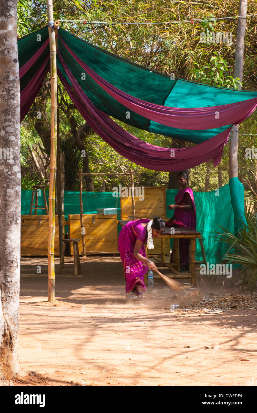 India Tamil Nadu Pondicherry Puducherry Auroville Matri Mandir meditation spiritual centre center park gardens tented area woman lady sweeping Stock Photo