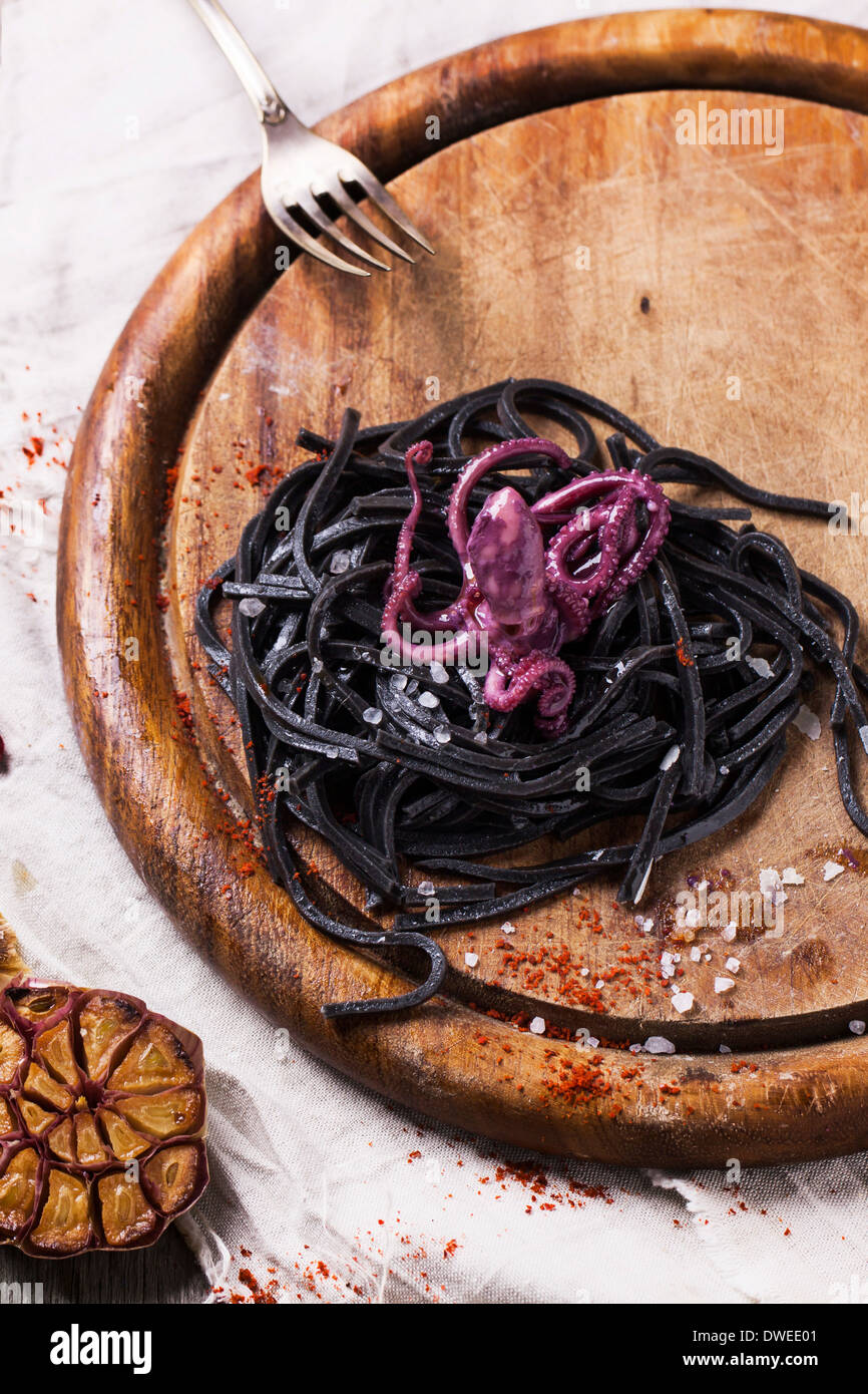 Black spaghetti (pasta with cuttlefish ink) with marinated octopus and