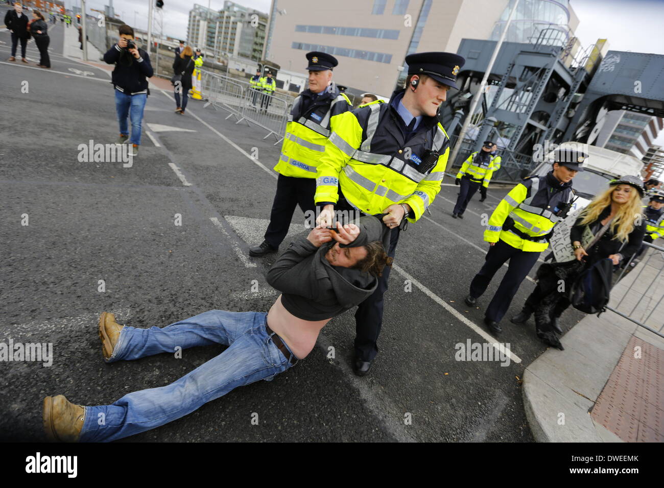 Dublin, Ireland. 6th March 2014. A Garda officer (Irish police) draggs