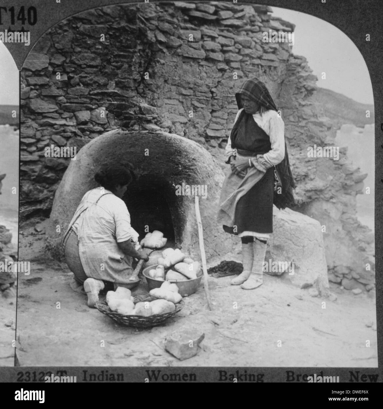 Two Native Americans Baking Bread, Laguna Pueblo, New Mexico, USA, circa 1900 Stock Photo