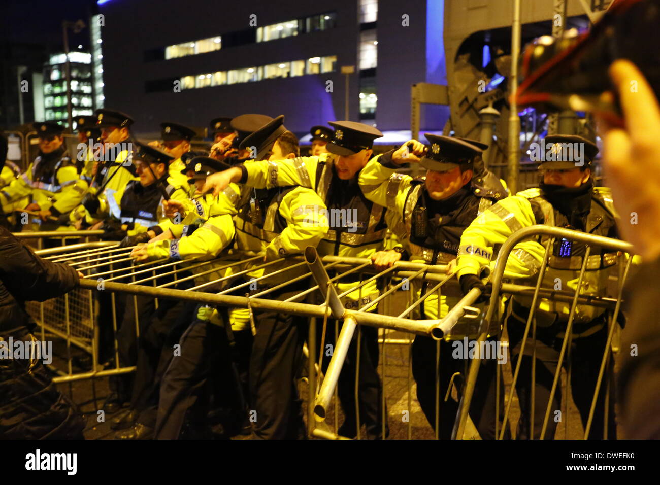 Dublin, Ireland. 6th March 2014. Garda officers (Irish police) pull at the metal barrier and