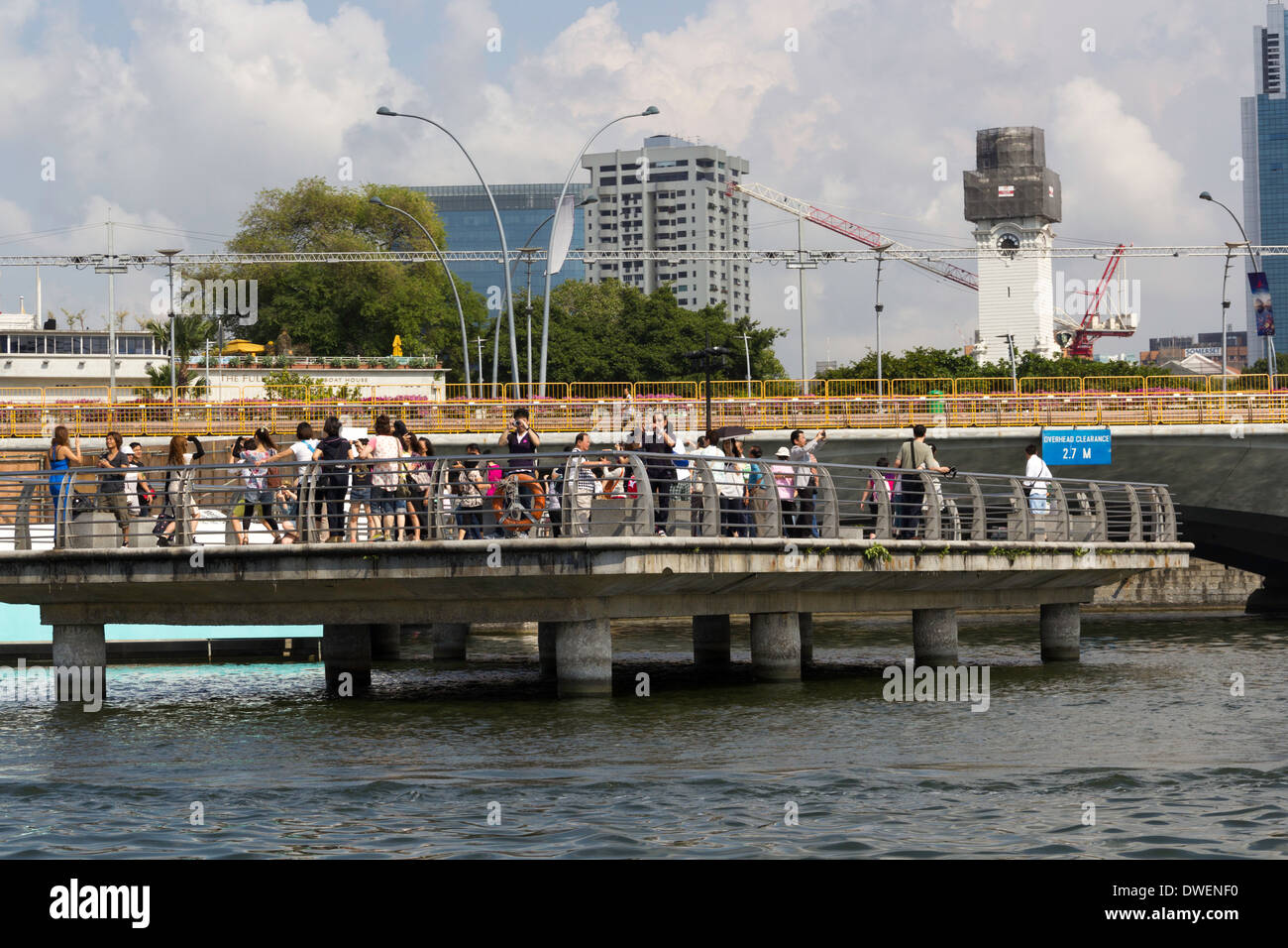 Visitors on viewing plaza on Singapore river next to the Merlion statue, built on a platform with support pillars Stock Photo