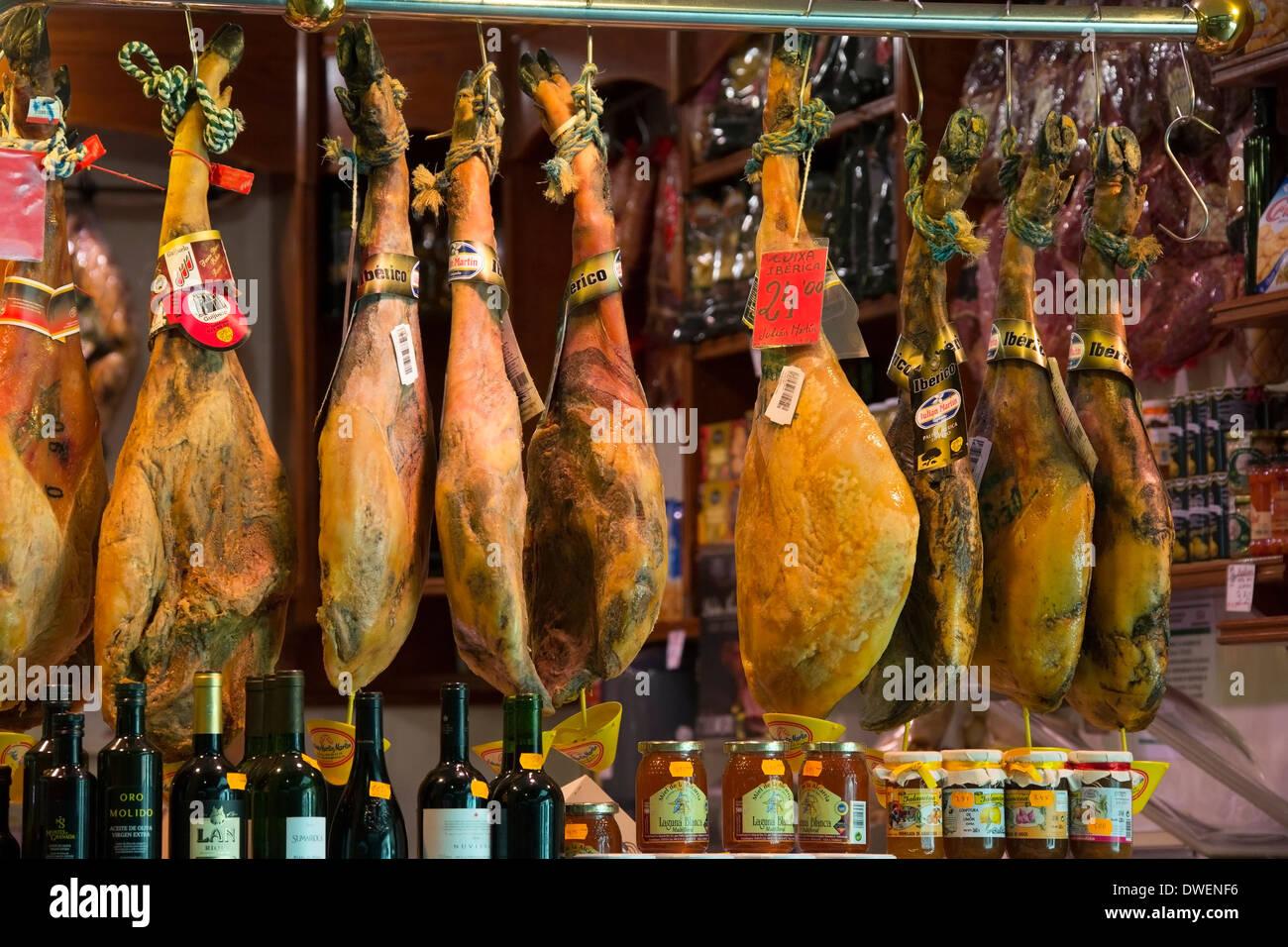 Serrano Ham and Jamon Iberico hanging in a shop in Barcelona in Spain Stock Photo