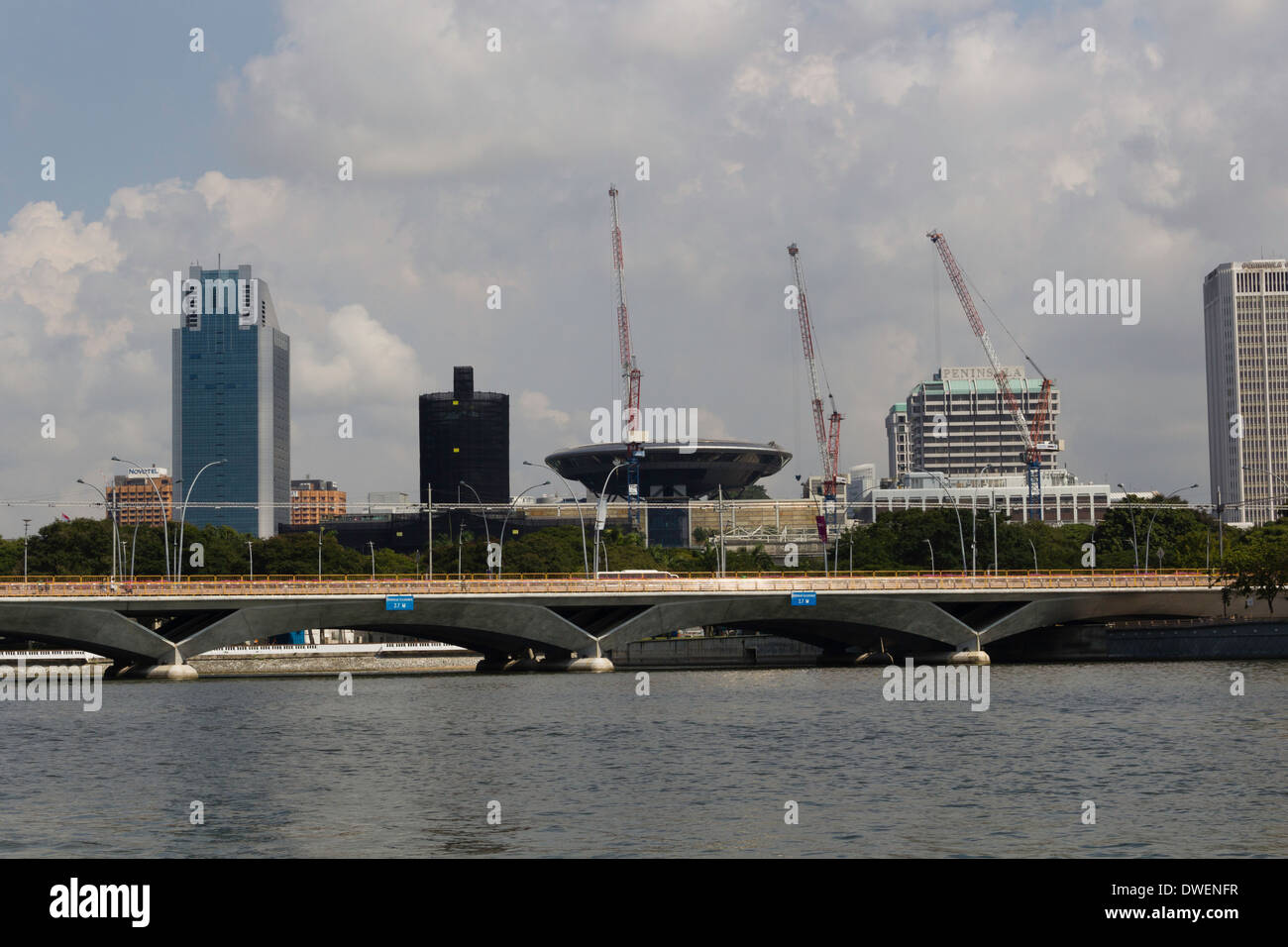 Bridge on the Marina reservoir and some construction cranes, a prime tourist area with the Merlion park very close by Stock Photo