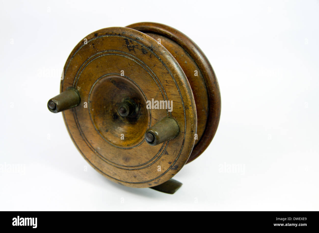 Old fashioned wooden centre pin fishing reel. Stock Photo