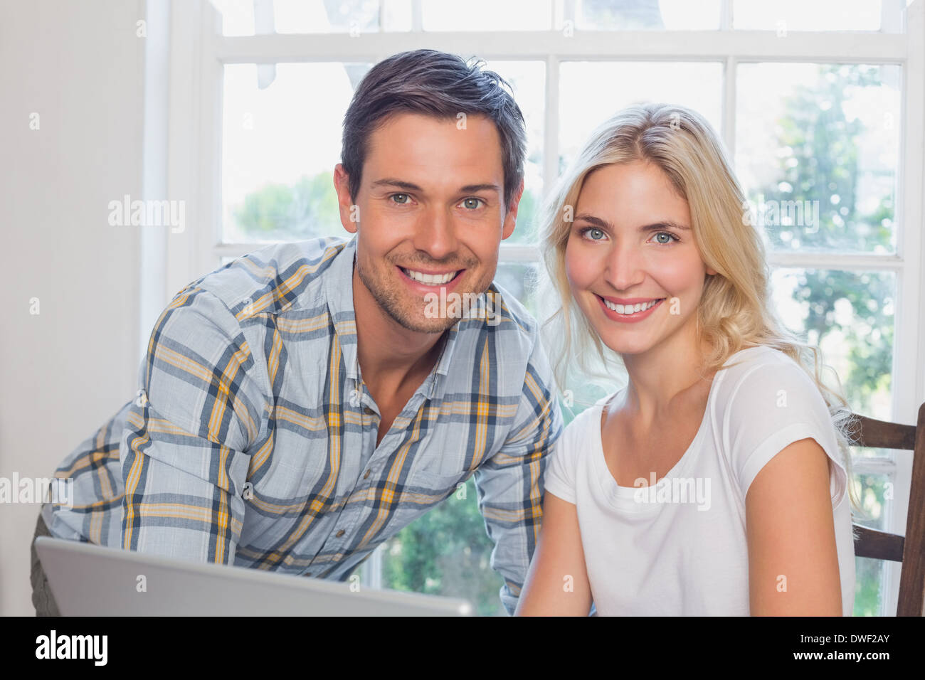 Happy young couple laptop hi-res stock photography and images - Alamy