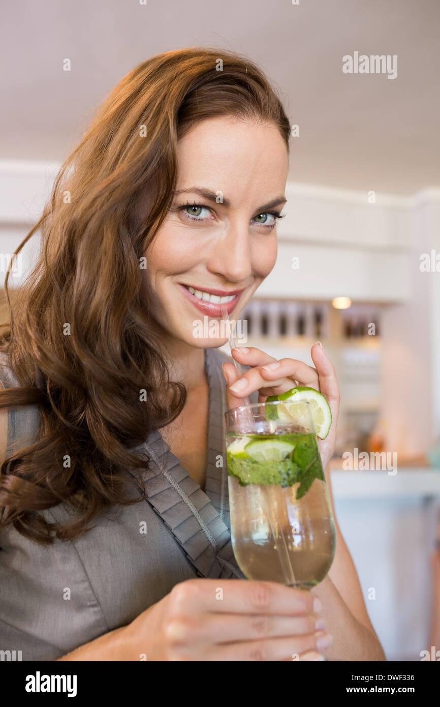 Closeup of a smiling young woman holding cocktail glass Stock Photo