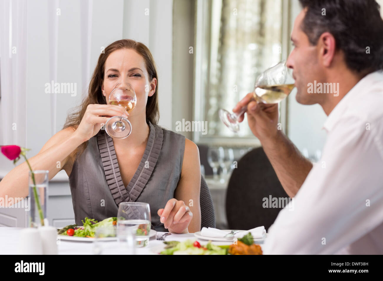 Couple drinking wine at dining table in restaurant Stock Photo