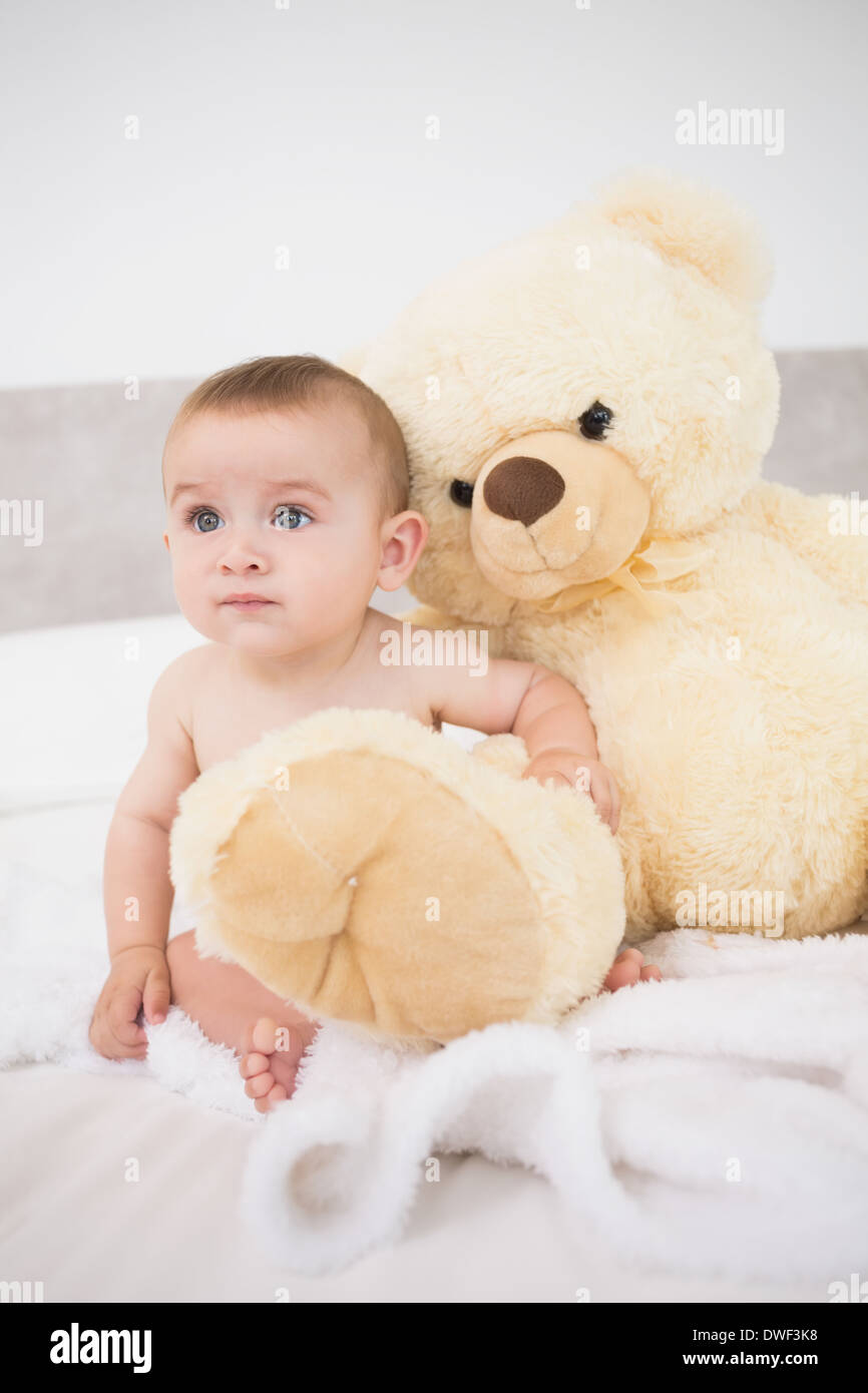 Baby boy with teddy bear in bed Stock Photo - Alamy