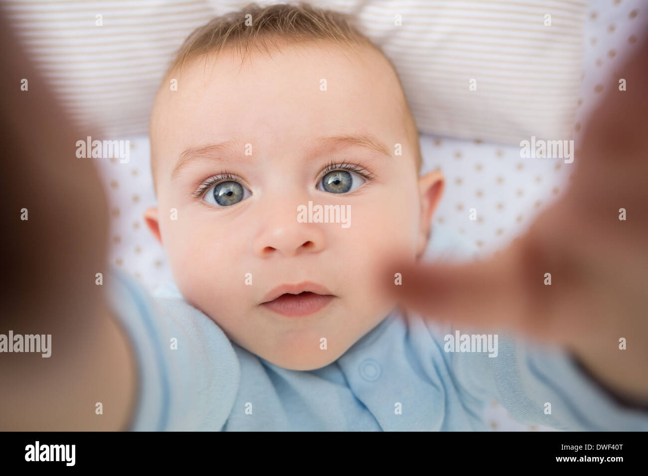 Cute baby boy lying in crib Stock Photo Alamy