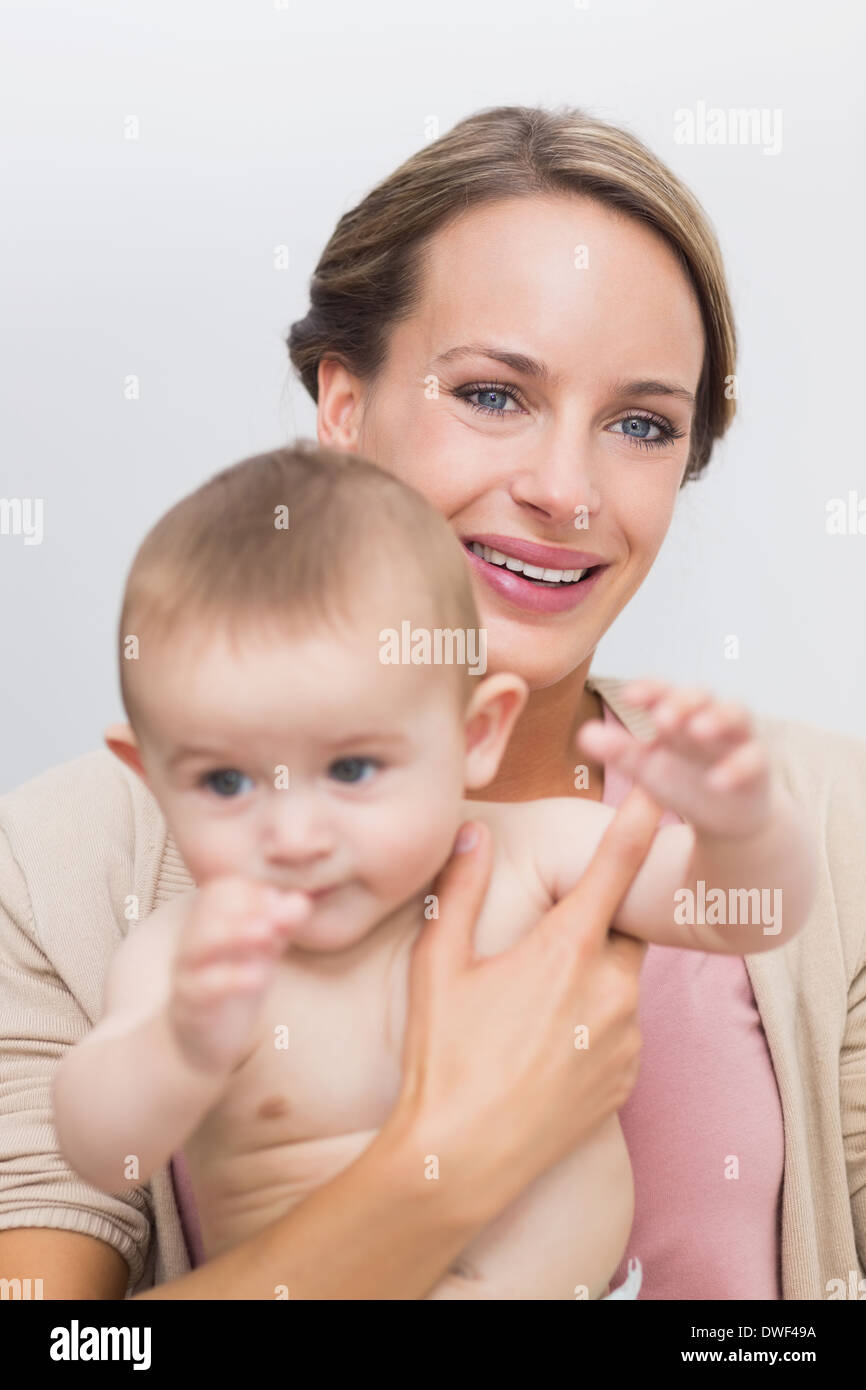 Happy mother carrying baby boy Stock Photo Alamy