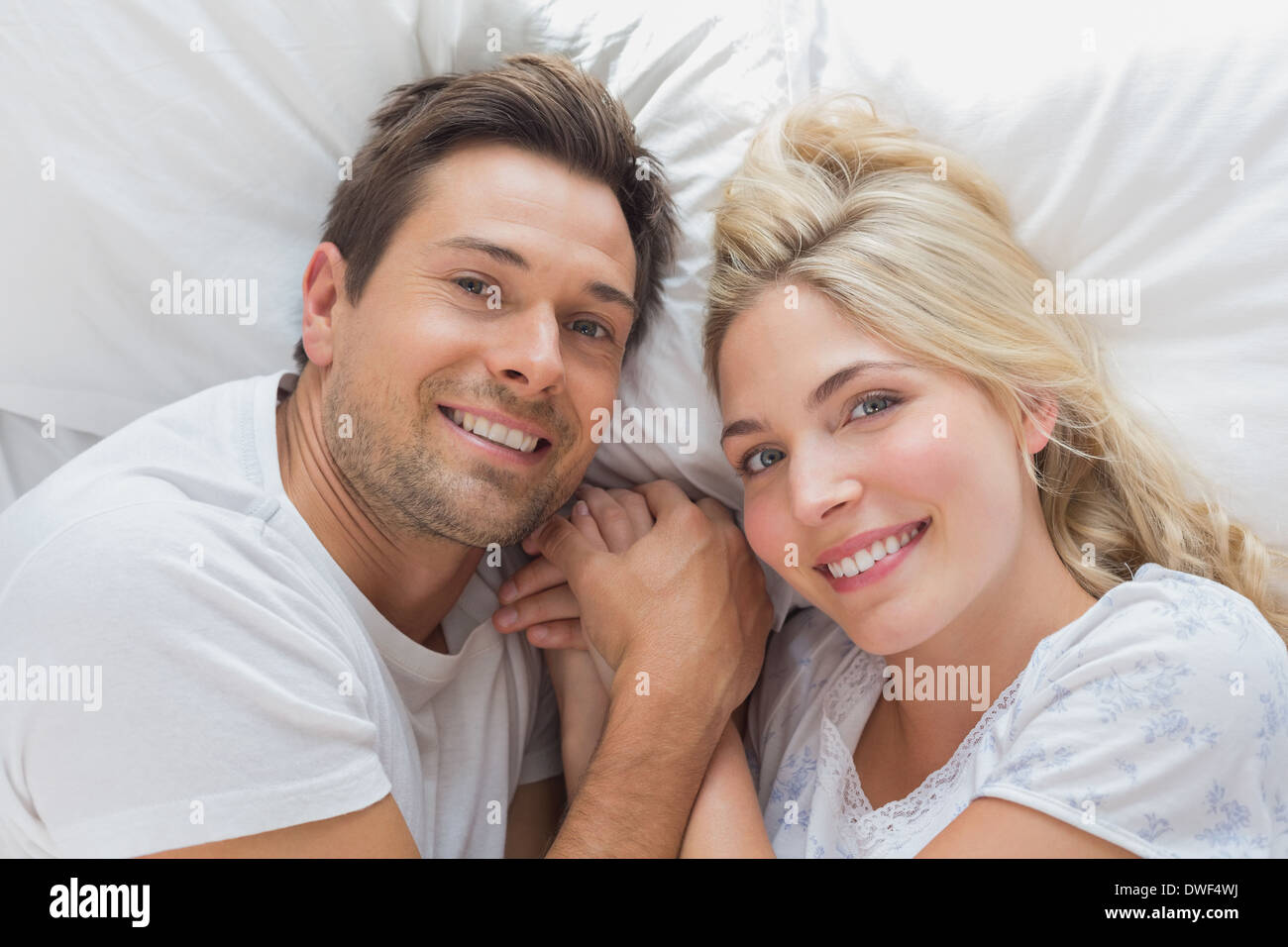 High angle portrait of a couple lying in bed Stock Photo - Alamy