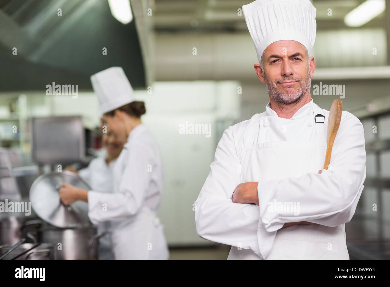 Premium Photo  Chef cook tasting food with wooden spoon at the restaurant  kitchen