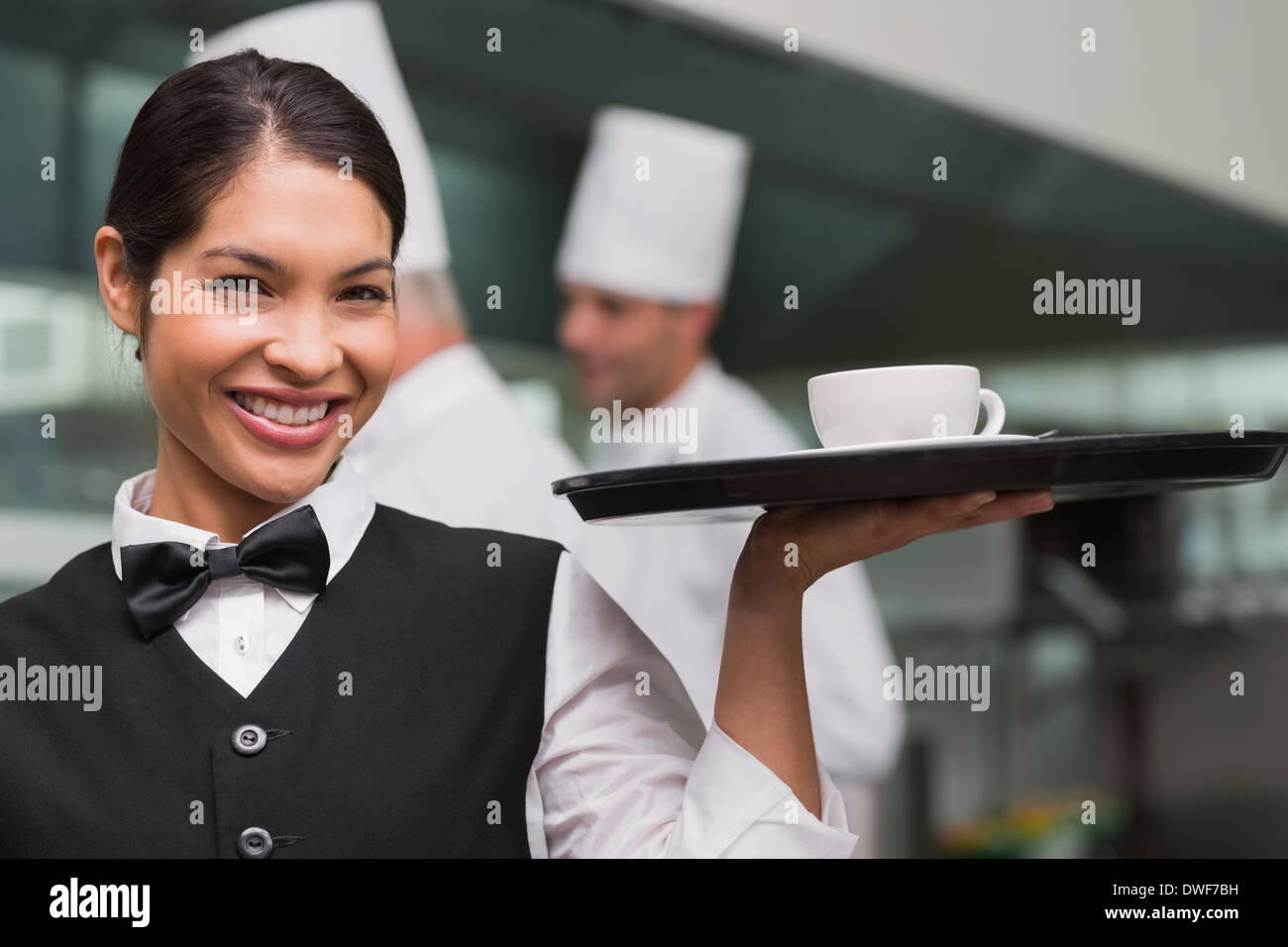 Happy waitress holding tray with coffee cup Stock Photo Alamy