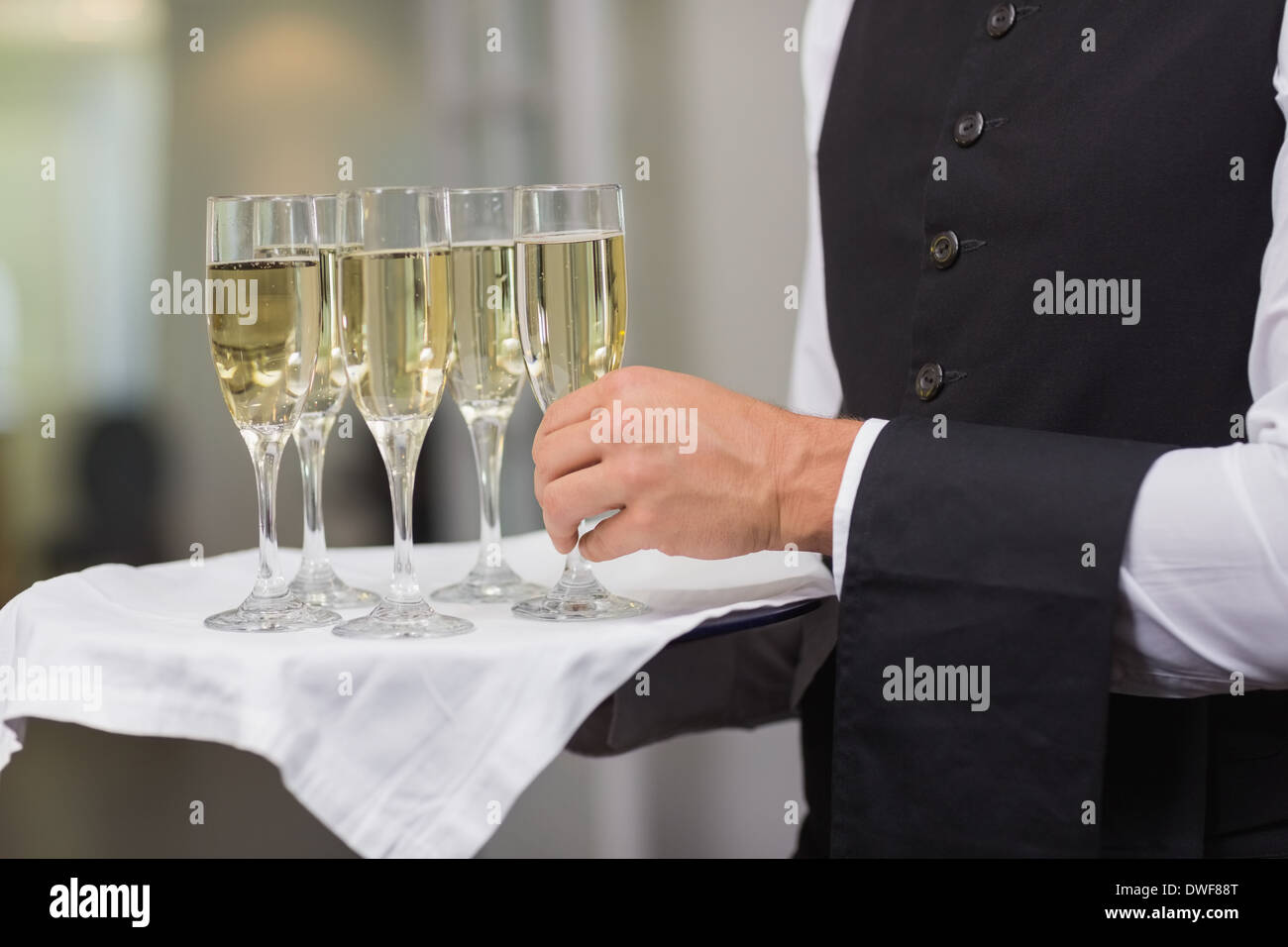 Waiter holding tray of champagne Stock Photo Alamy