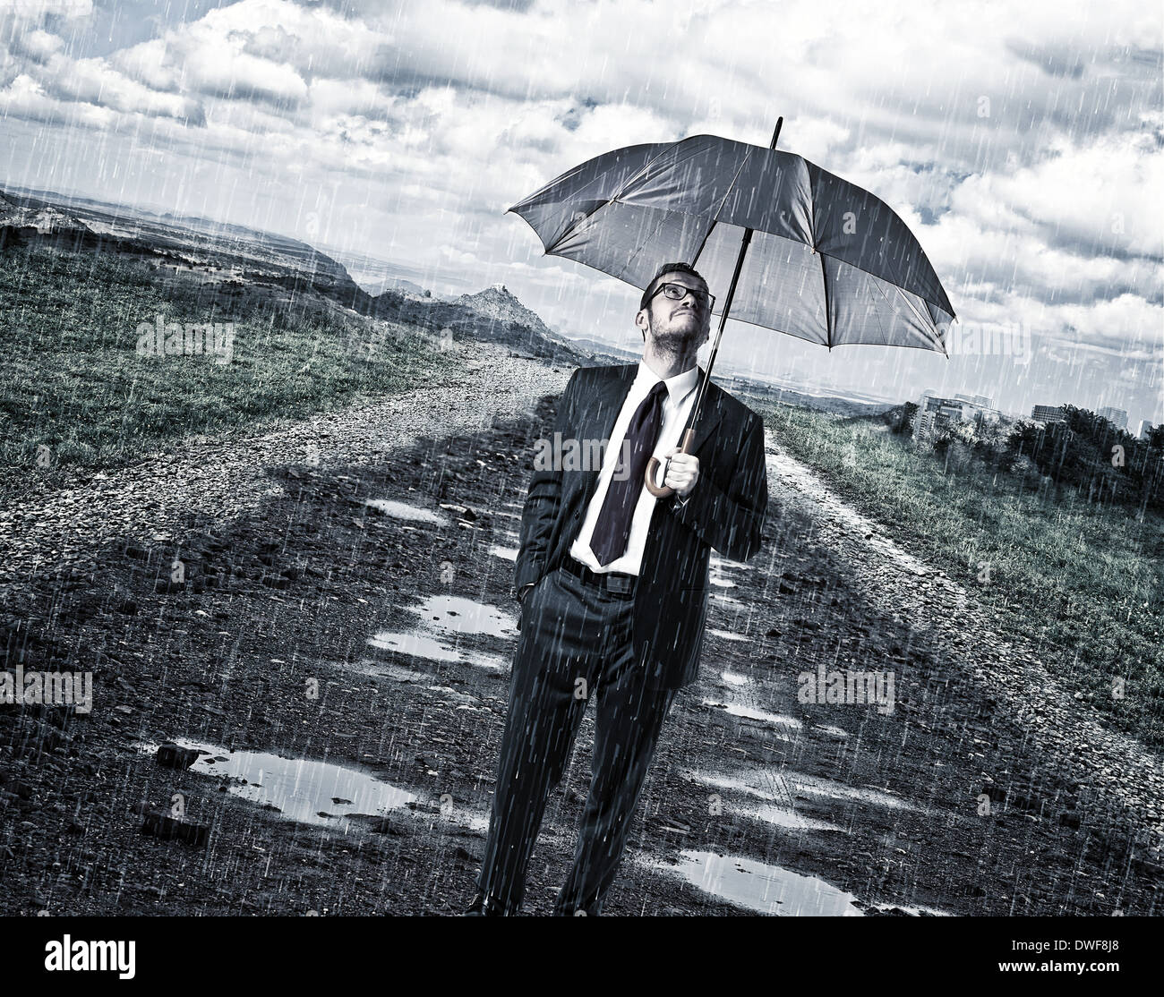 rainy day and man with umbrella on road Stock Photo