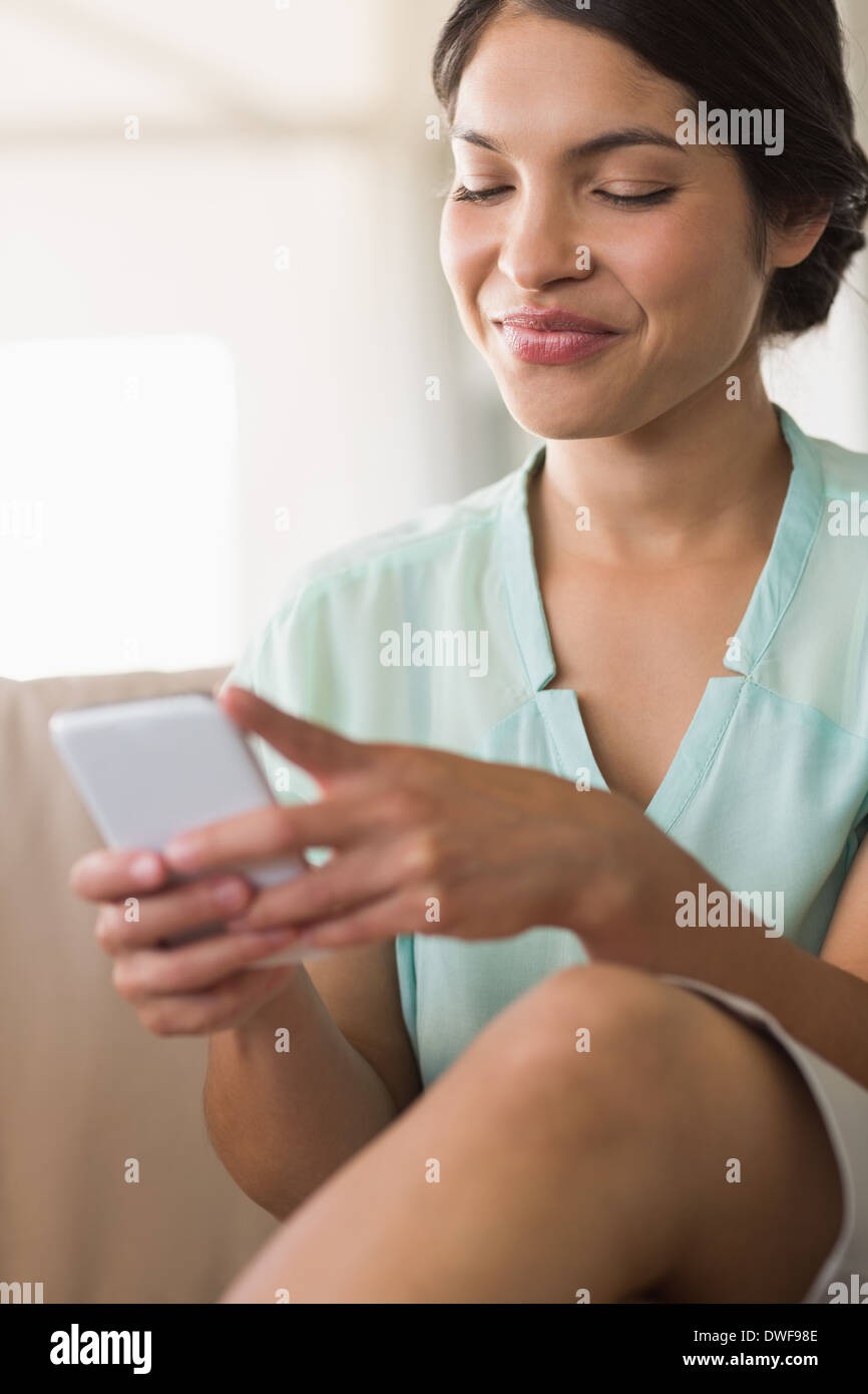 Businesswoman sending a text message Stock Photo