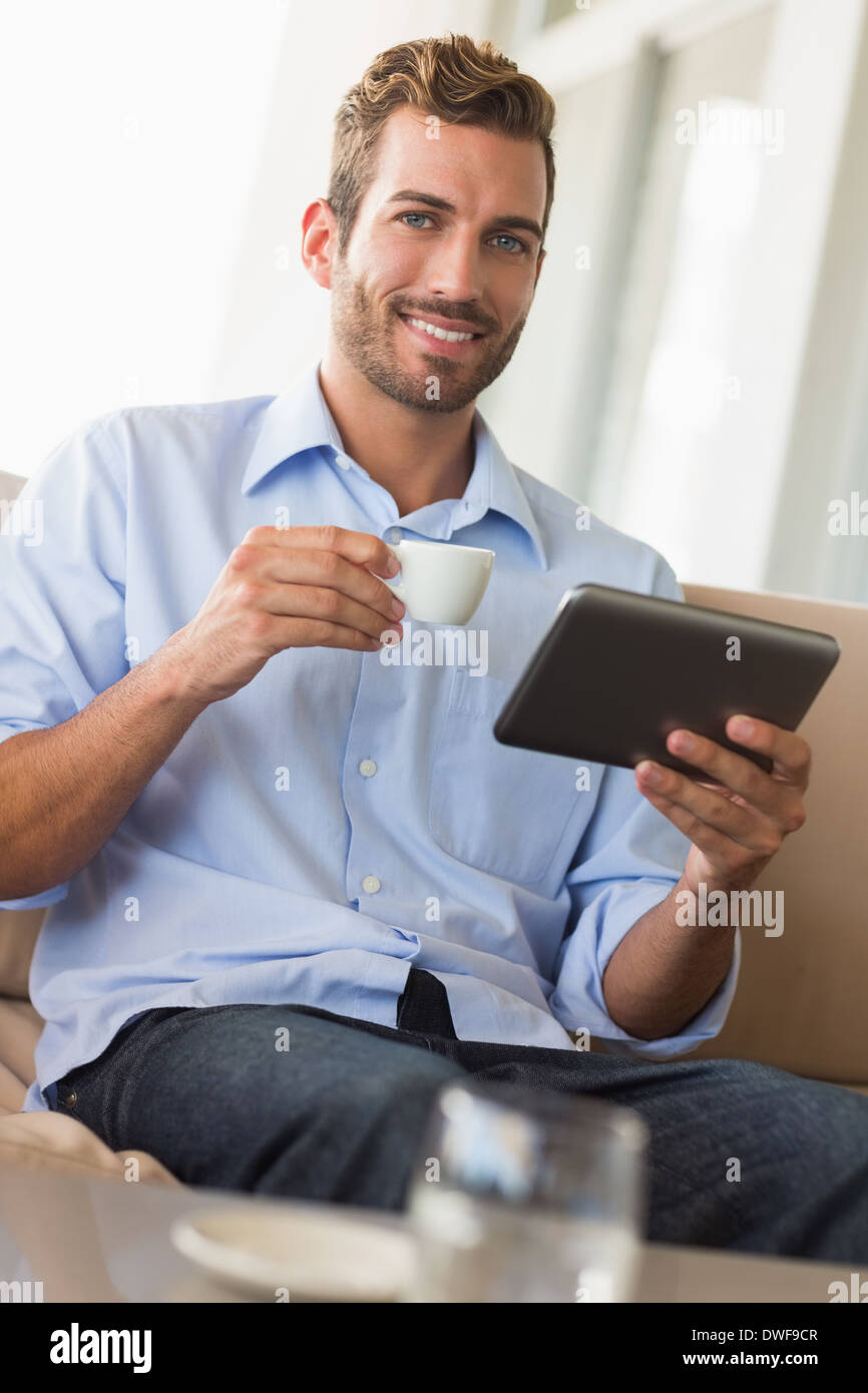 Handsome businessman working on tablet pc drinking espresso Stock Photo