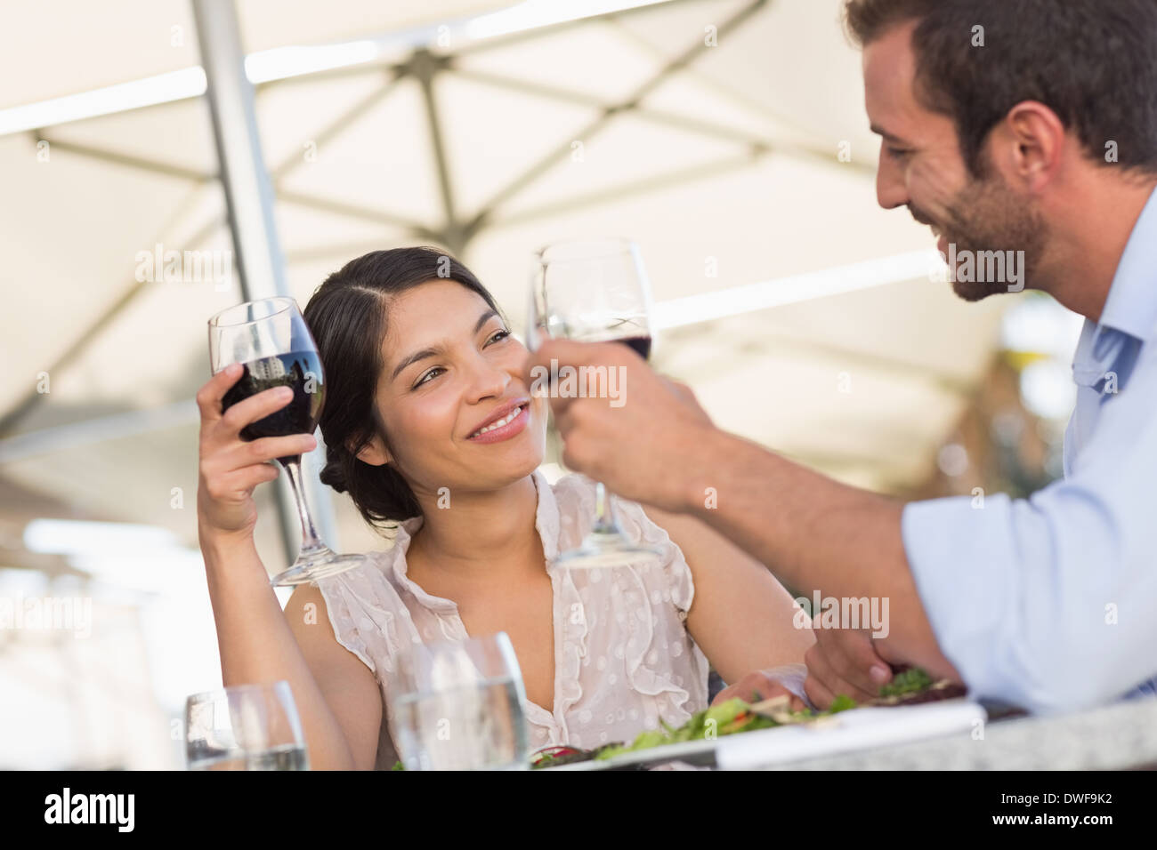 Happy couple on a date drinking red wine Stock Photo