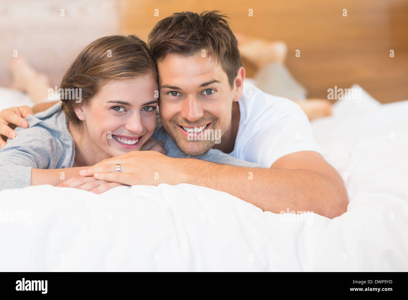 Happy couple lying on a bed Stock Photo