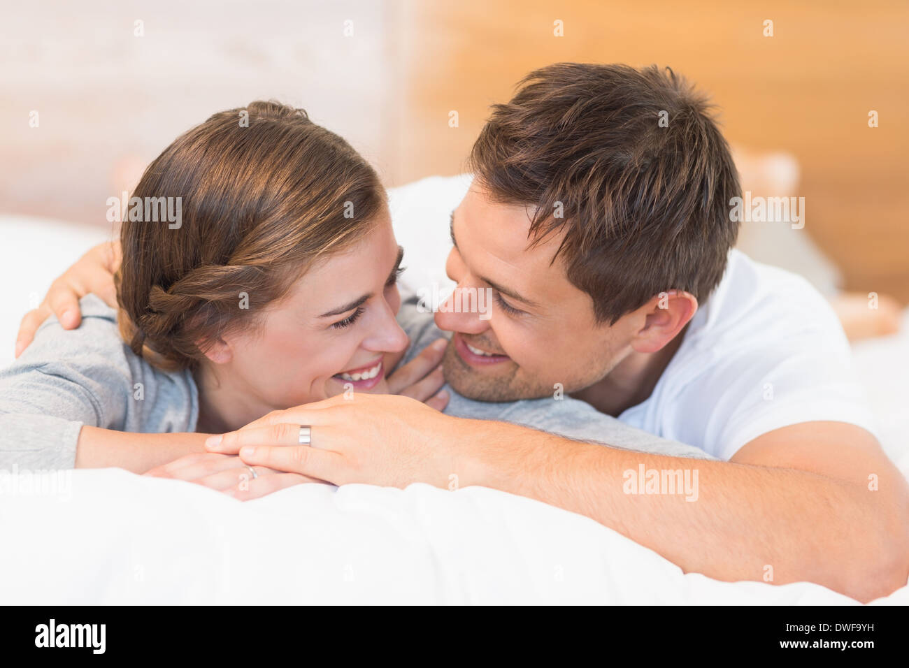 Happy couple lying on a bed Stock Photo