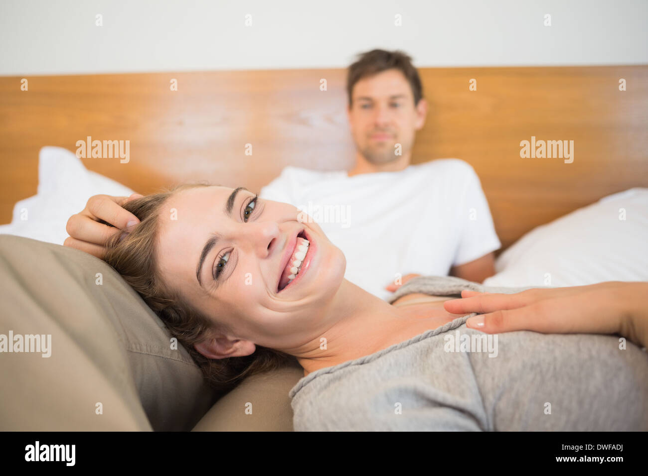 Happy couple relaxing on bed Stock Photo