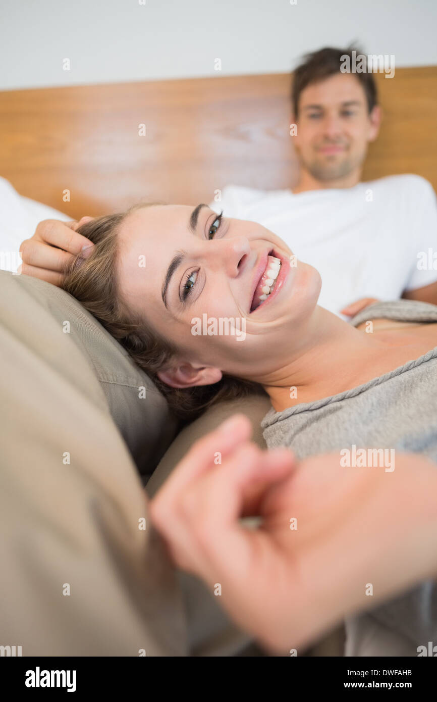 Happy couple relaxing on bed Stock Photo